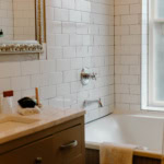 A cozy bathroom with white subway tiles, bathtub, and natural light in Eureka Springs.