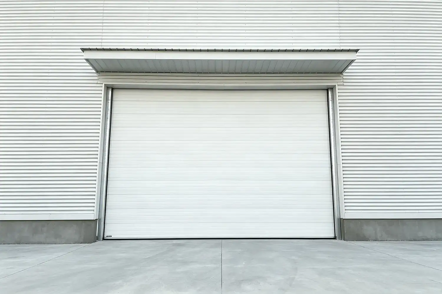 Energy-efficient industrial sectional door installed on a modern warehouse exterior to reduce HVAC energy costs