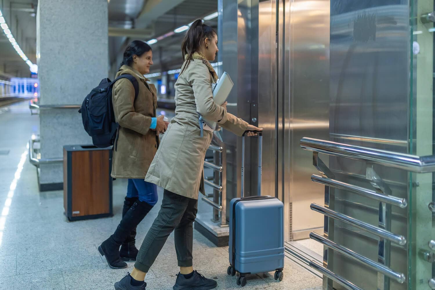 Passengers entering a modern elevator in a commercial building