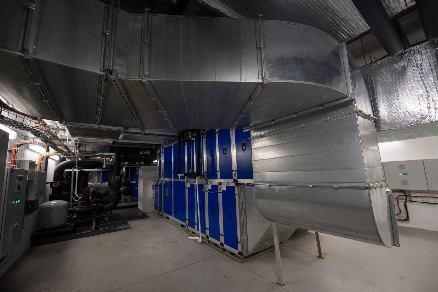 Ventilation ductwork and mechanical equipment inside an elevator machine room
