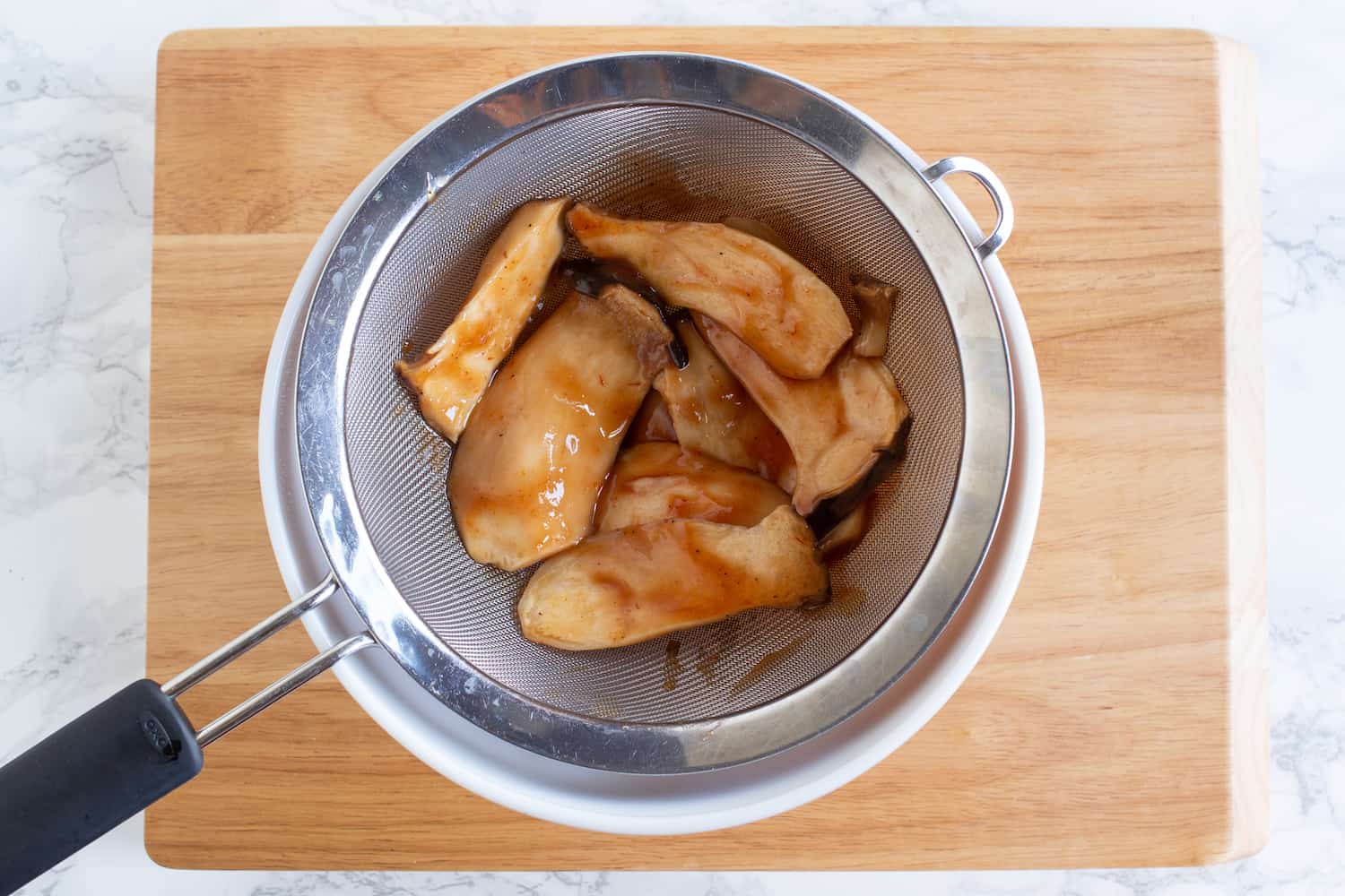 marinated mushrooms in a strainer