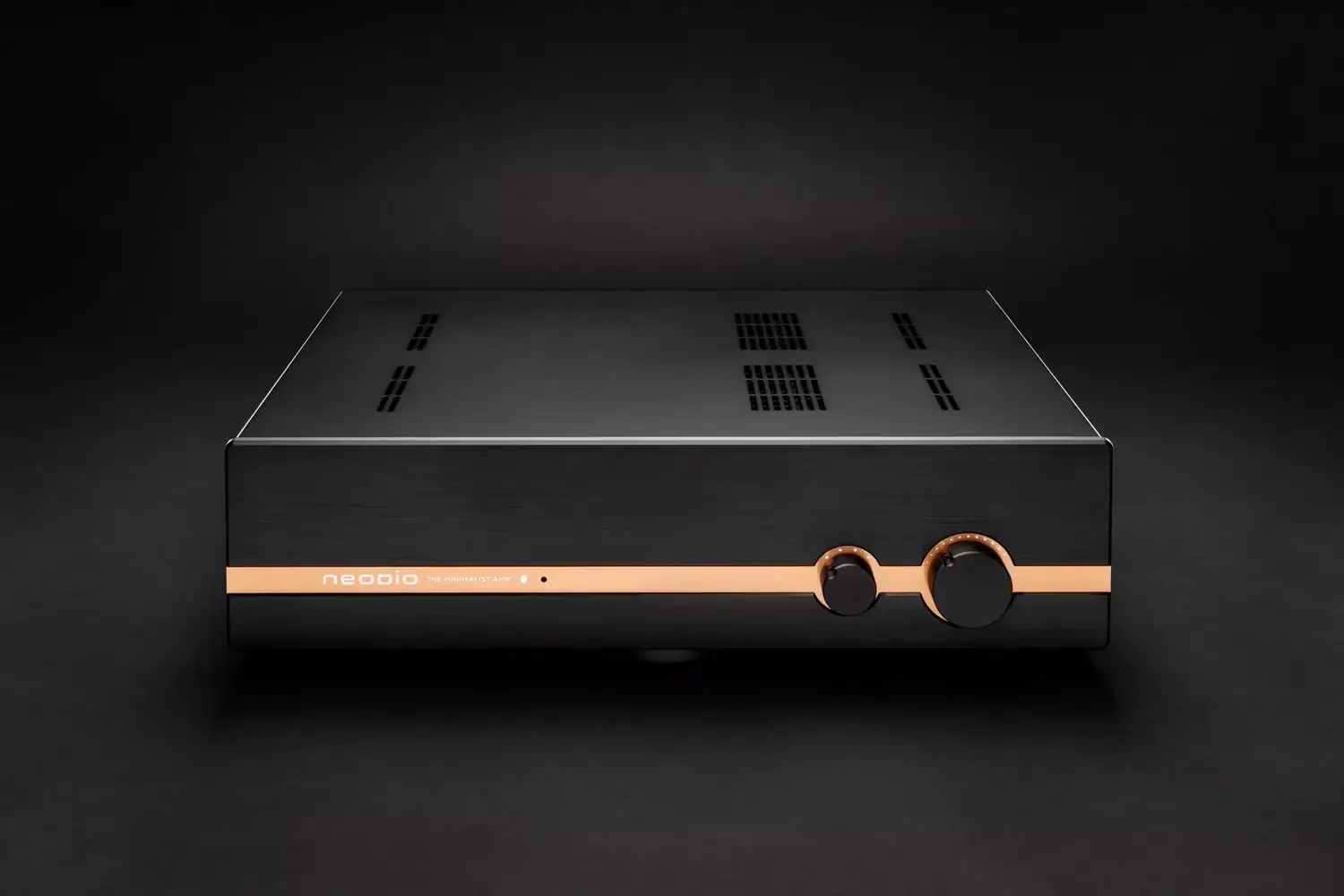 Neodio TMA sur un décor noir, vue de face avec un léger angle qui permet de voir le capot supérieur ajouré à plusieurs endroits et notamment à l'aplomb des dissipateurs thermiques passifs situés à l'intérieur