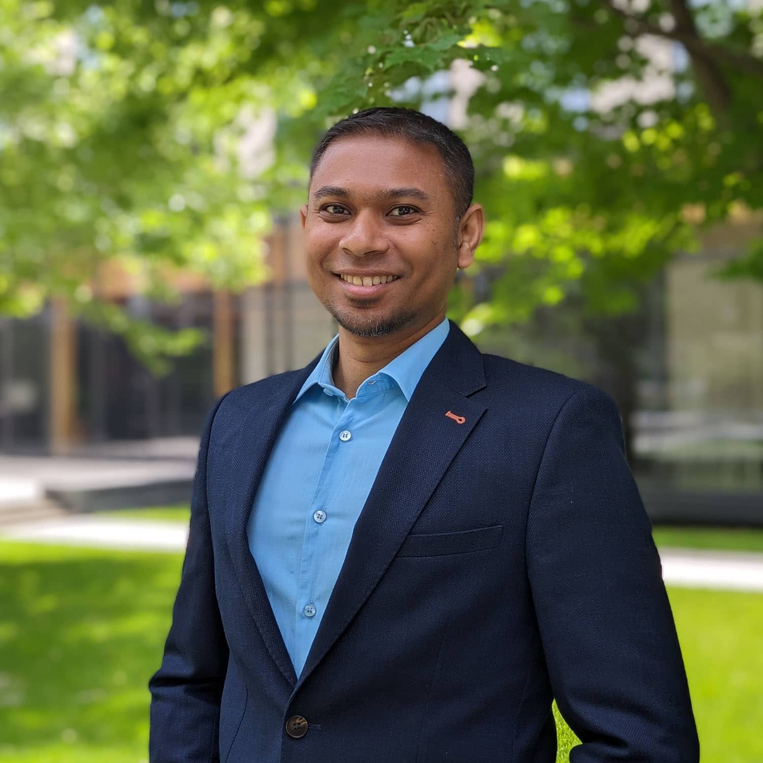 Man smiling in suit outside