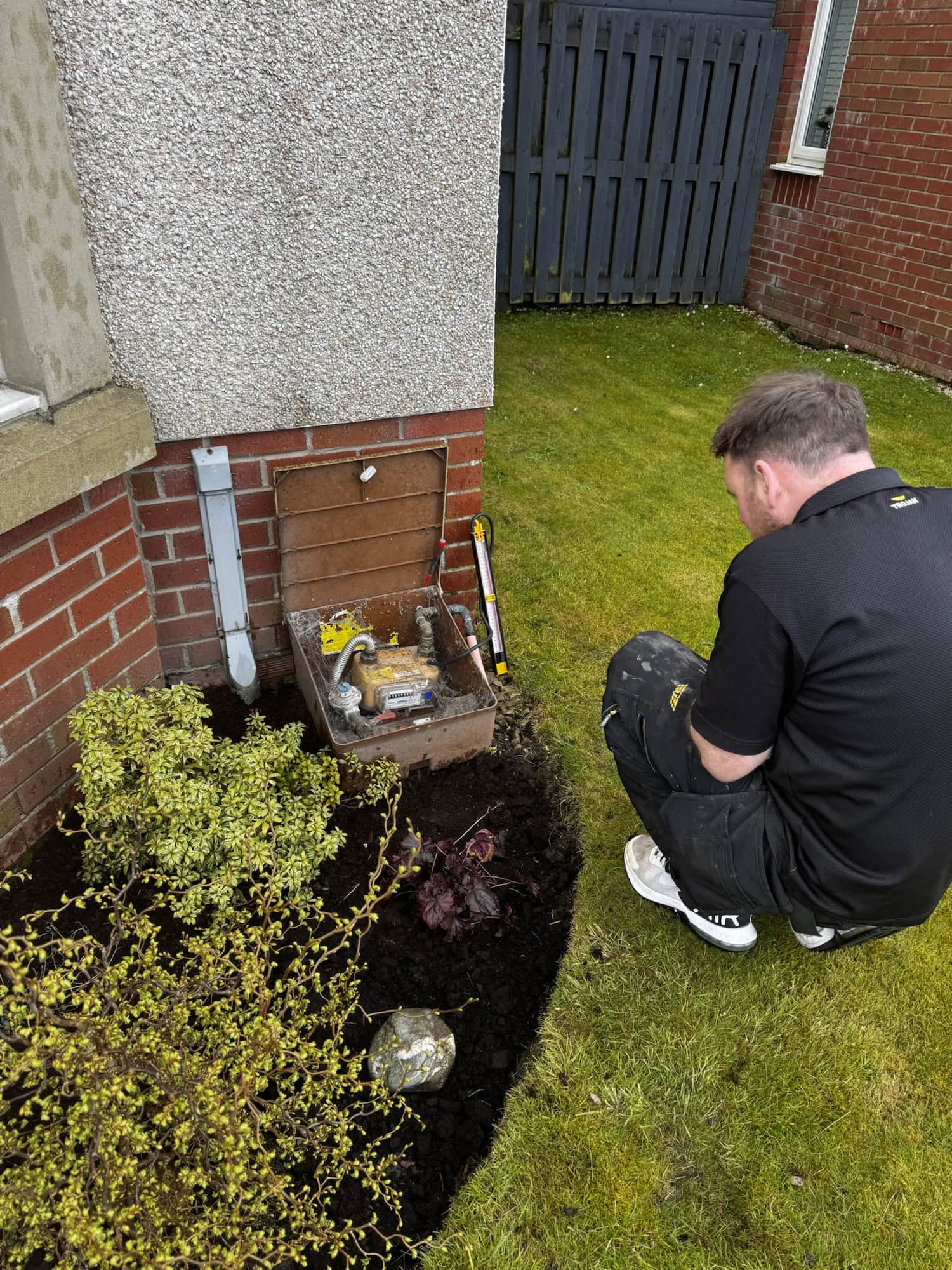 Gas Safe Engineer conducting test on gas meter to ensure eboile installation is compliant.