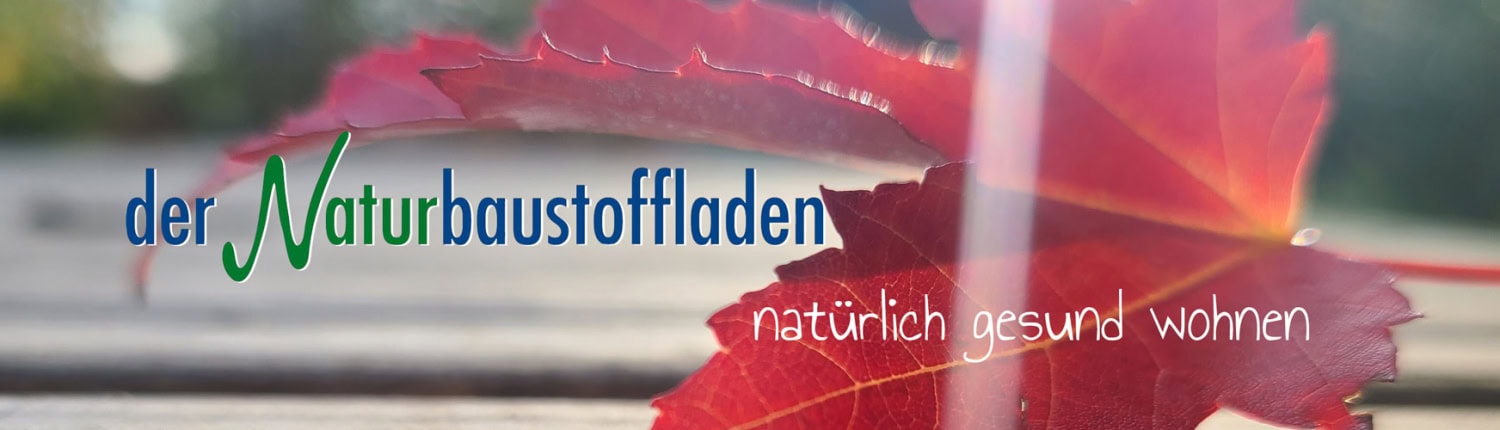 Banner mit rotem Ahornblatt, Schriftzug „der Naturbaustoffladen“ und dem Slogan „natürlich gesund wohnen“.