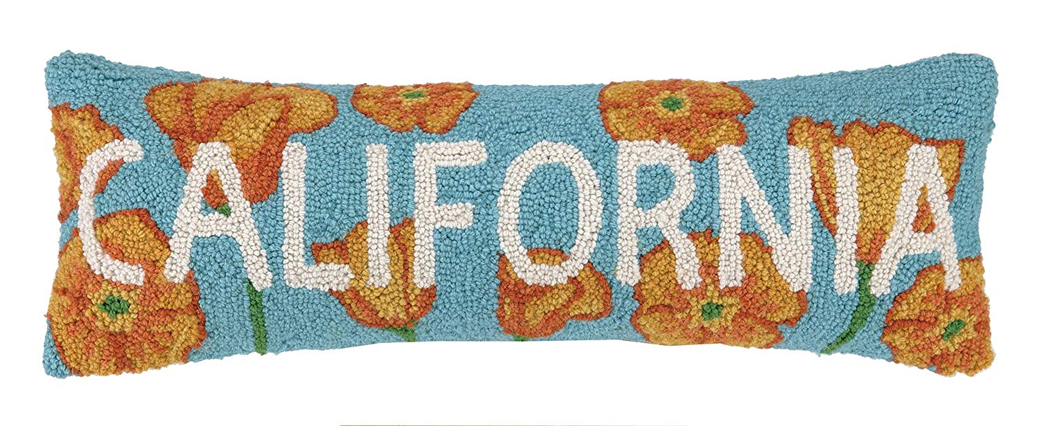 a blue decorative pillow with poppies