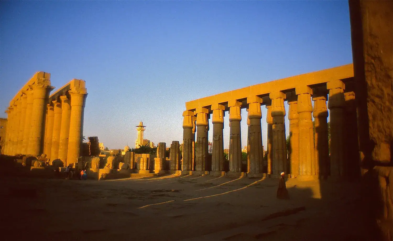 Luxor Temple sandstone courtyard and columns glowing at sunset