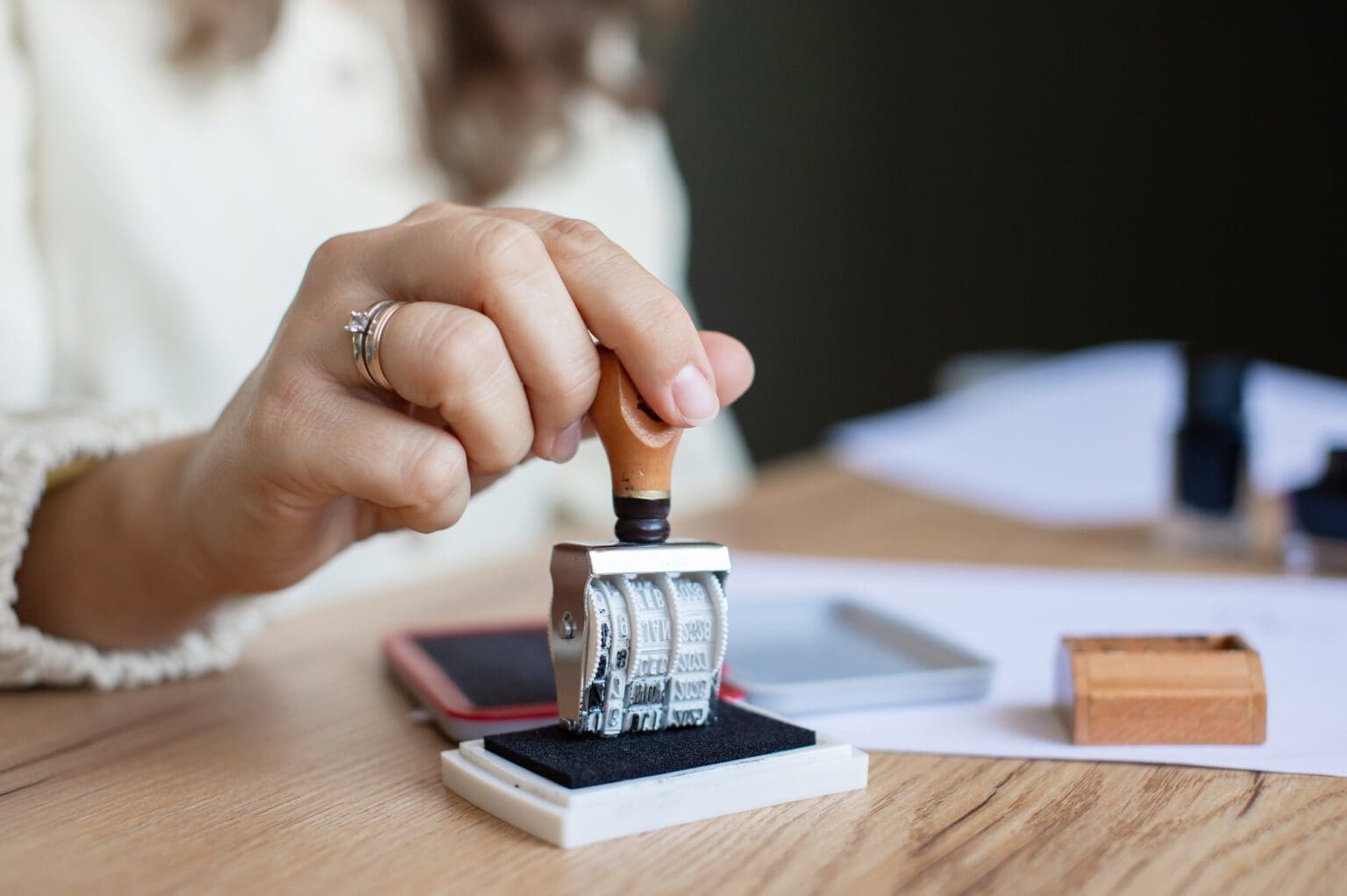 Woman Stamping Document in Office Setting