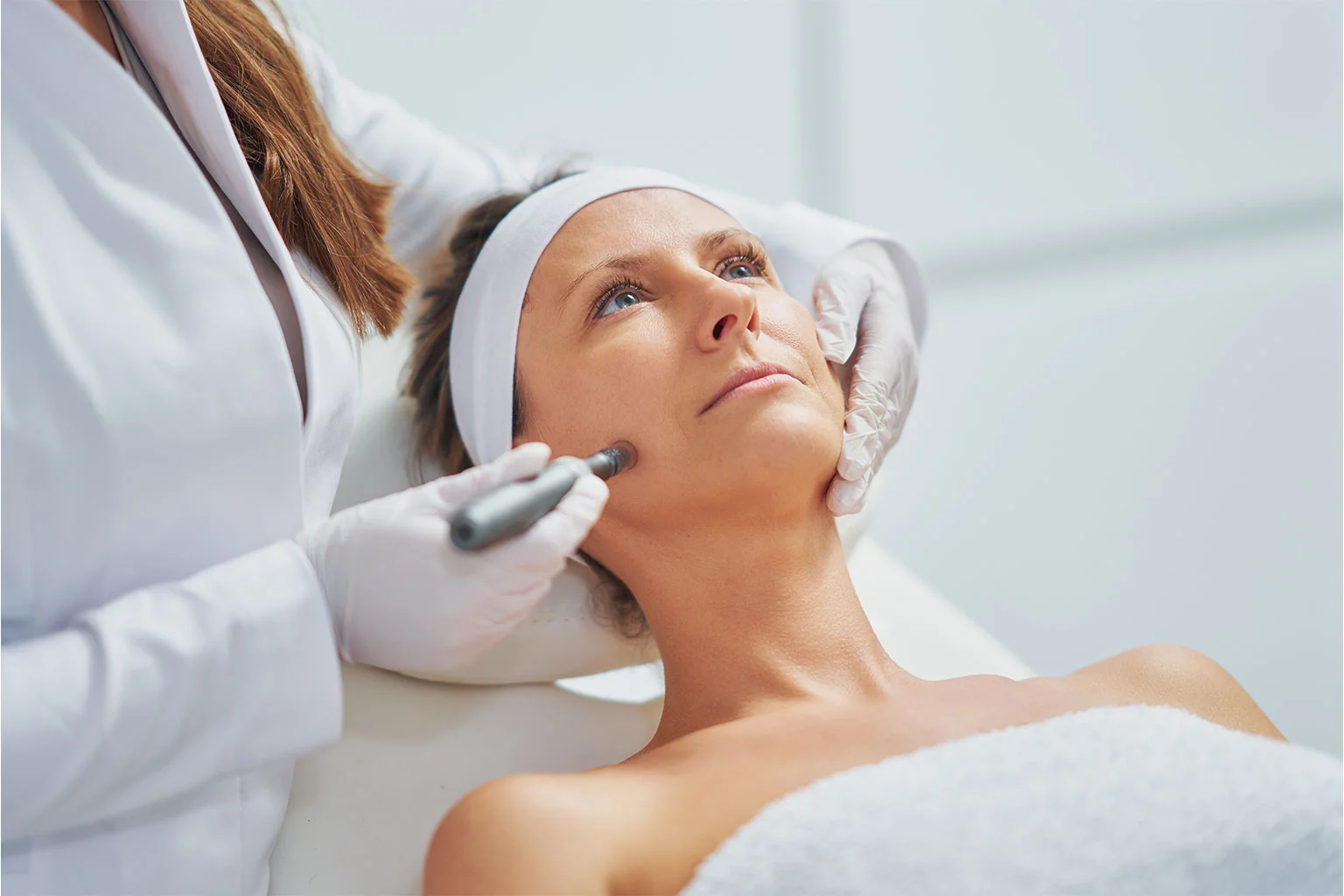 Woman getting mesotherapy treatment with dermapen