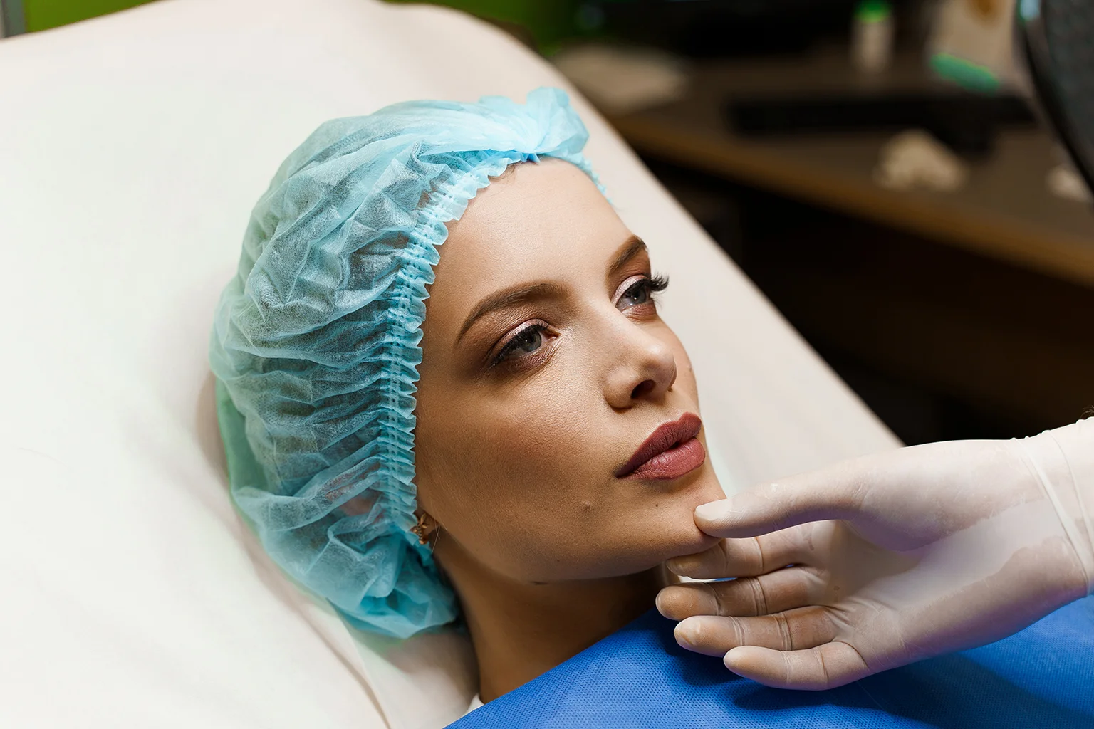 Doctor assessing a patient's face post-mesolipo fat dissolve treatment