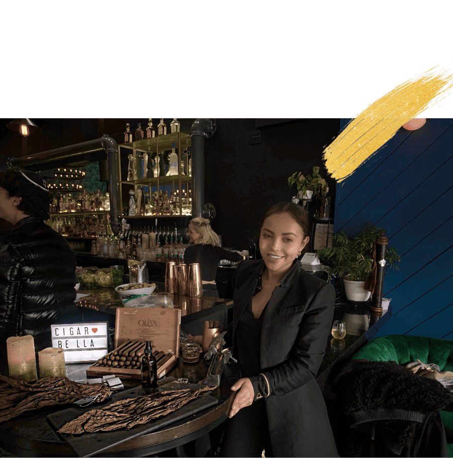 professional female cigar roller providing live cigar rolling for a corporate and luxury event