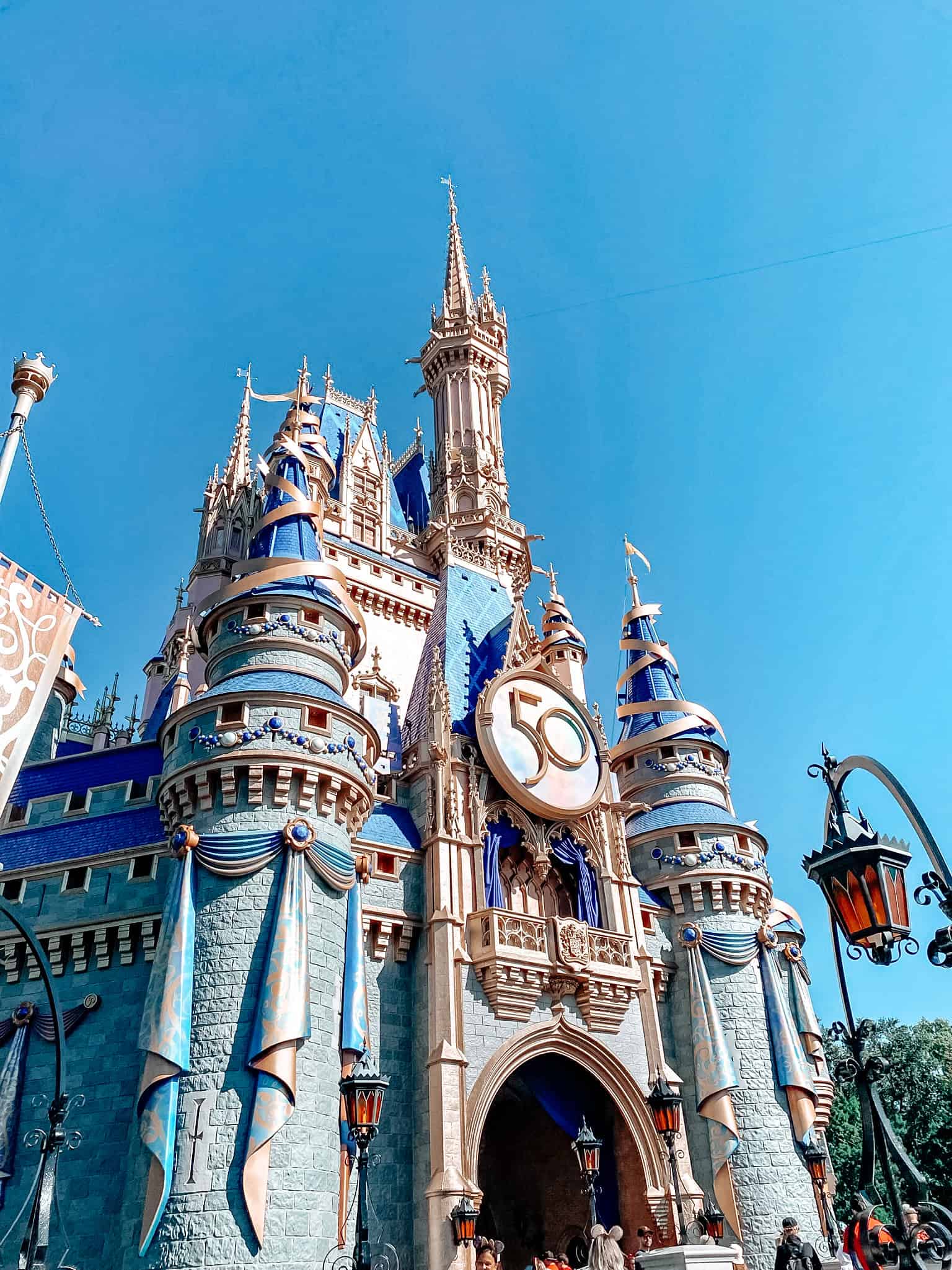 Colorful Disney castle at Magic Kingdom, Orlando, Florida, celebrating 50 years of enchantment and magic.