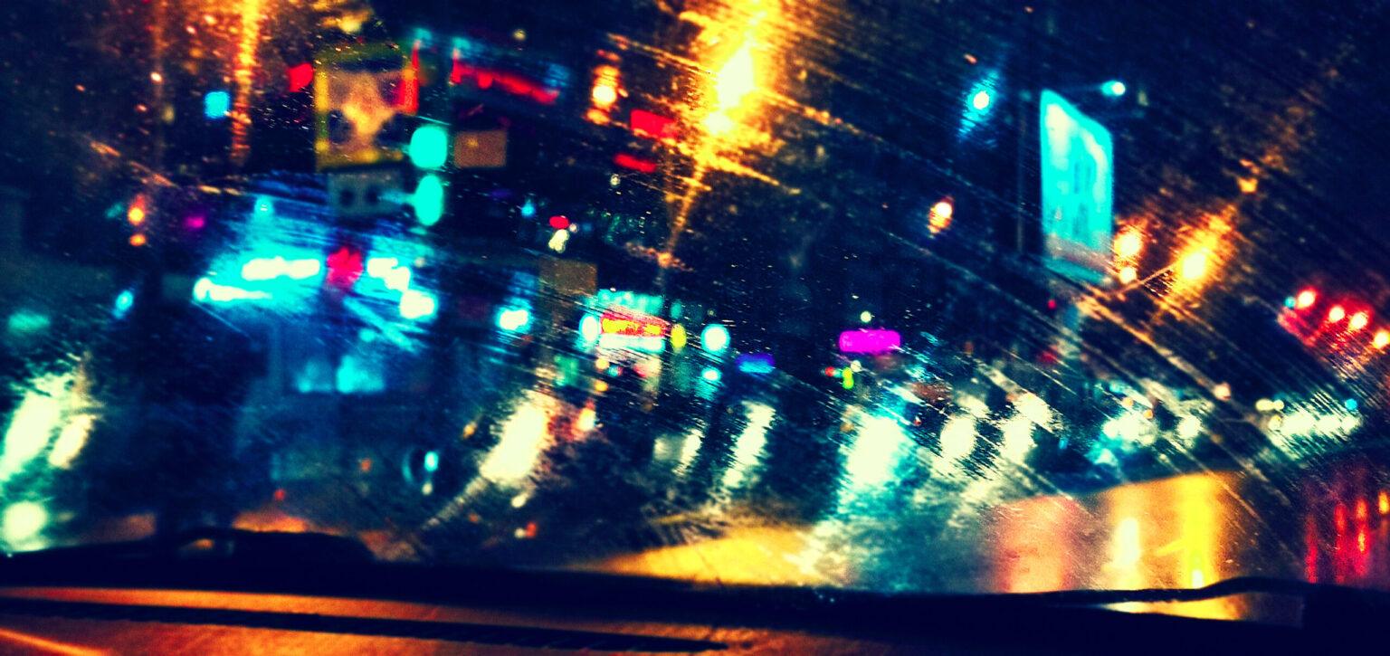 colored blurry lights, front car window, rainy