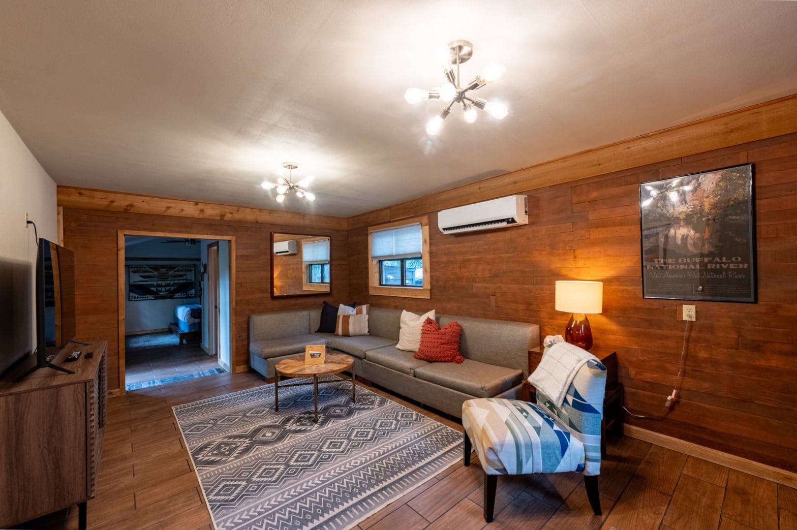 Cozy living room in a Eureka Springs cabin with wood accents and modern decor.