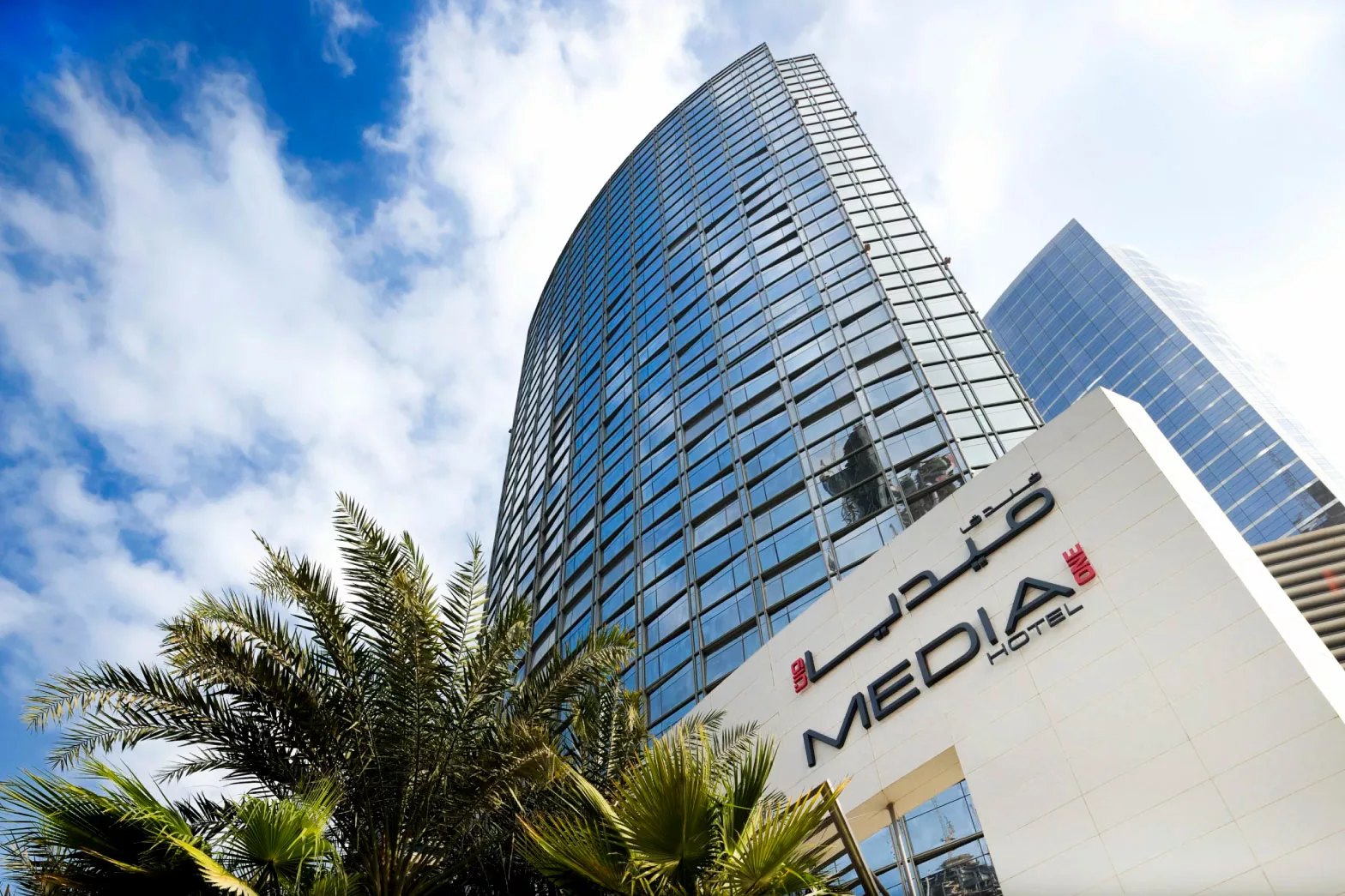 Exterior-scaled Media One Hotel from outside with the camera pointed upwards showcasing the height of the hotel.