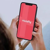 Traveler using Holafly eSIM on phone