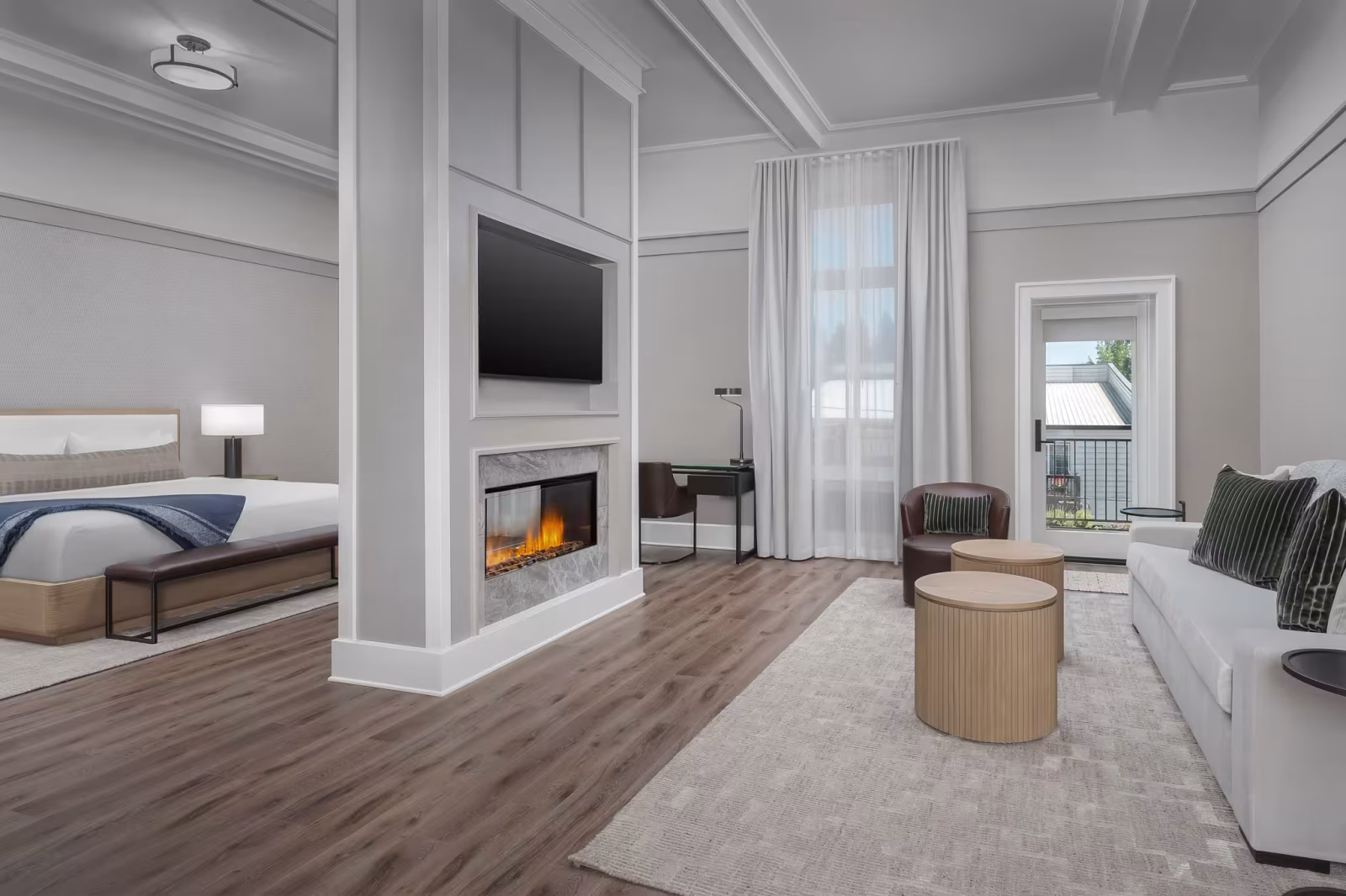 Spacious guest suite at The Inn at Dayton with fireplace, seating area, and private balcony—boutique lodging near Newberg in Oregon wine country.