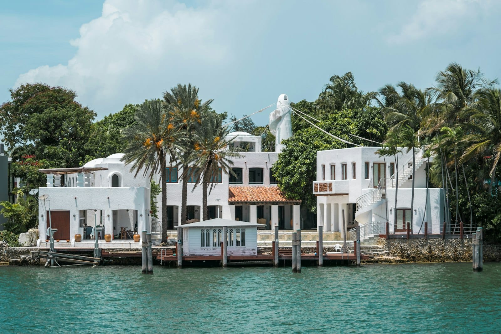 Aerial view of a white waterfront mansion in Miami
