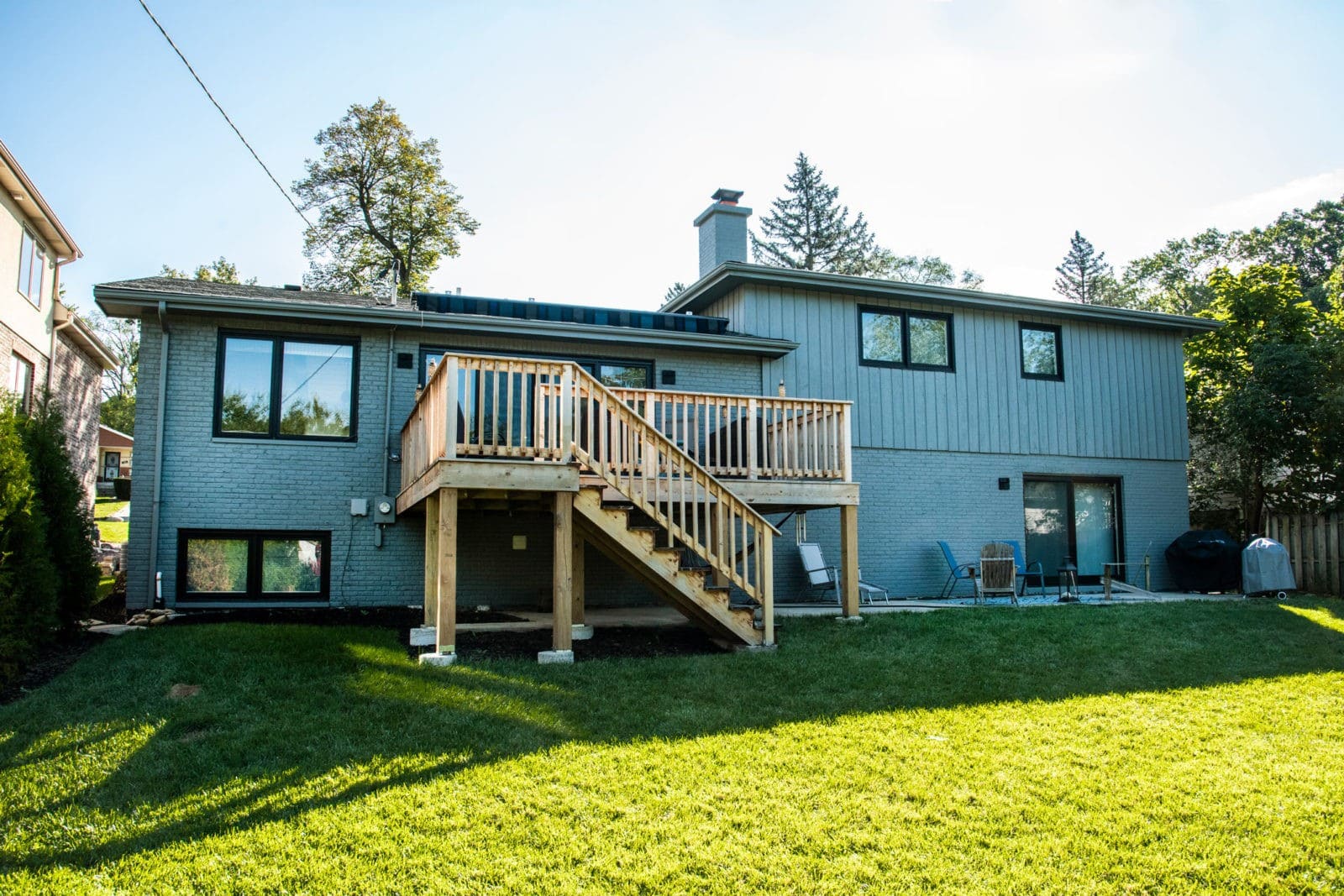 LivCo exterior home renovation and remodel deck addition grey painted home