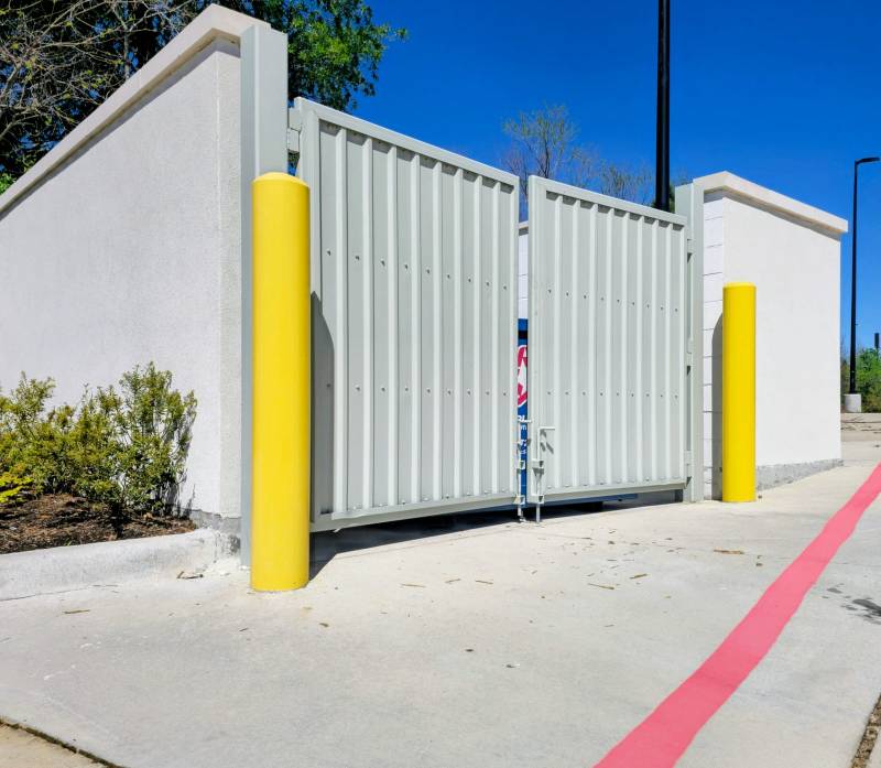 Yellow-painted bollards at a commercial property