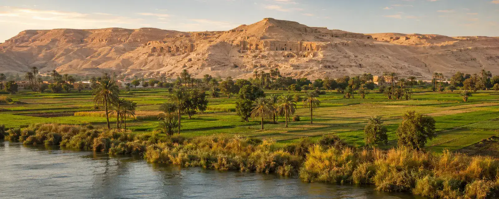 Minya Egypt Nile landscape with green fields and limestone cliffs
