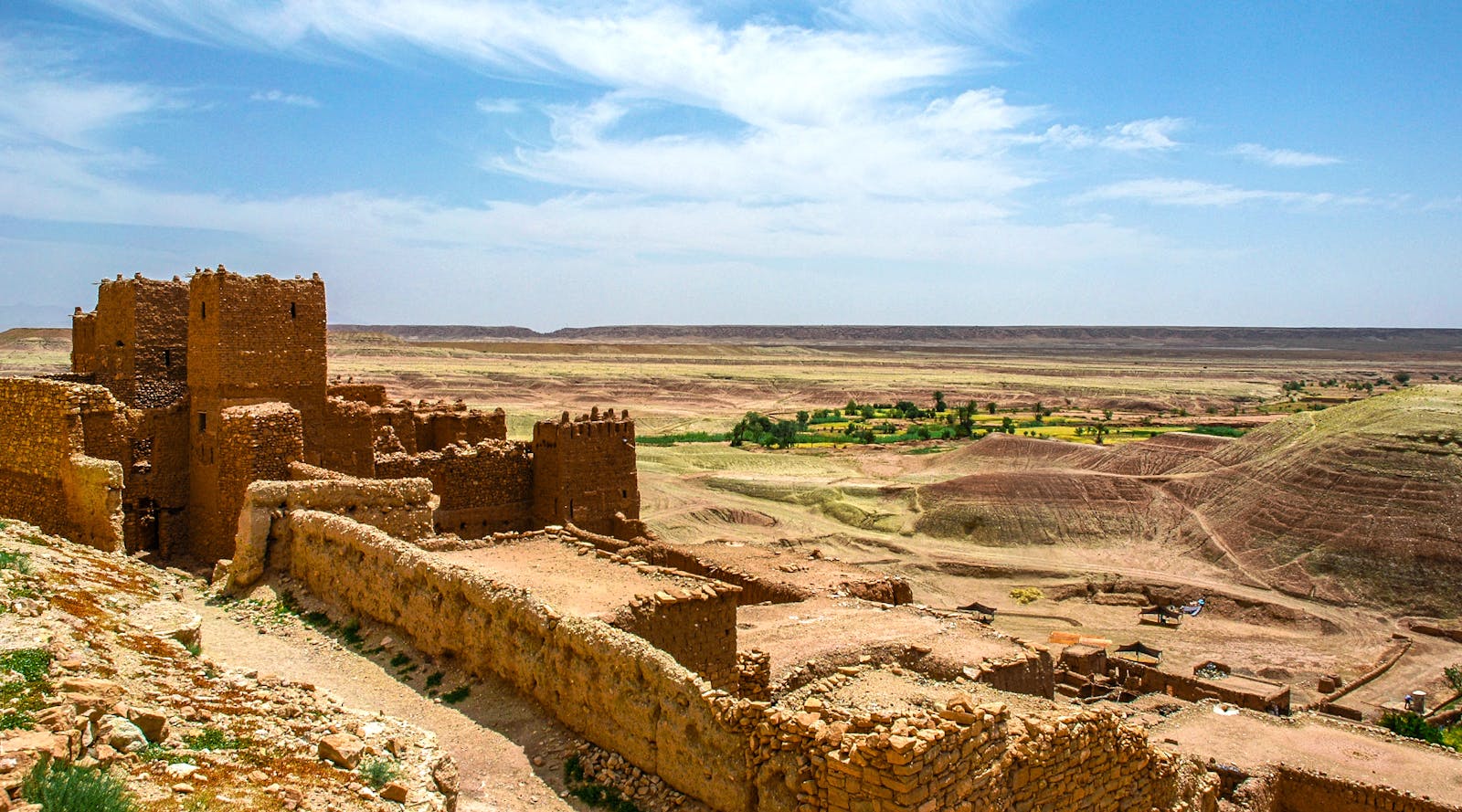Explore the majestic ruins of a fortress amidst the arid landscapes of Zagora, Morocco.