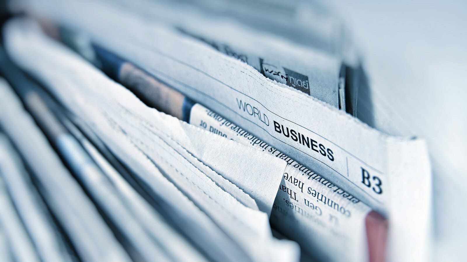 Business magazines and newspapers on a table, representing Forbes PR coverage