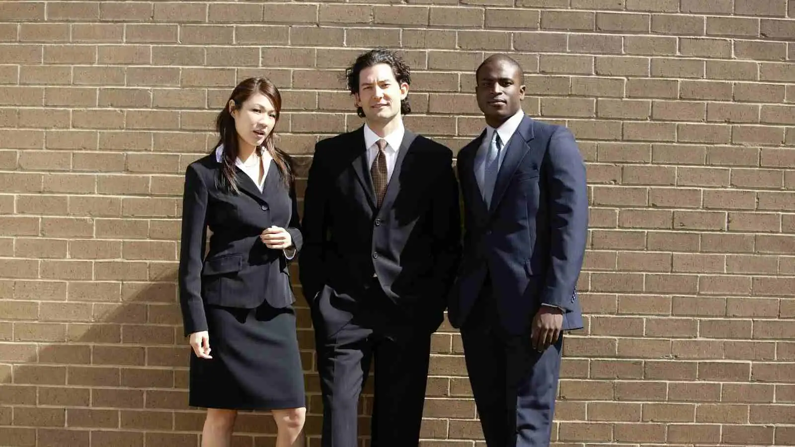 Comparison of business attire, with one side showcasing casual Canadian dress and the other formal American attire.