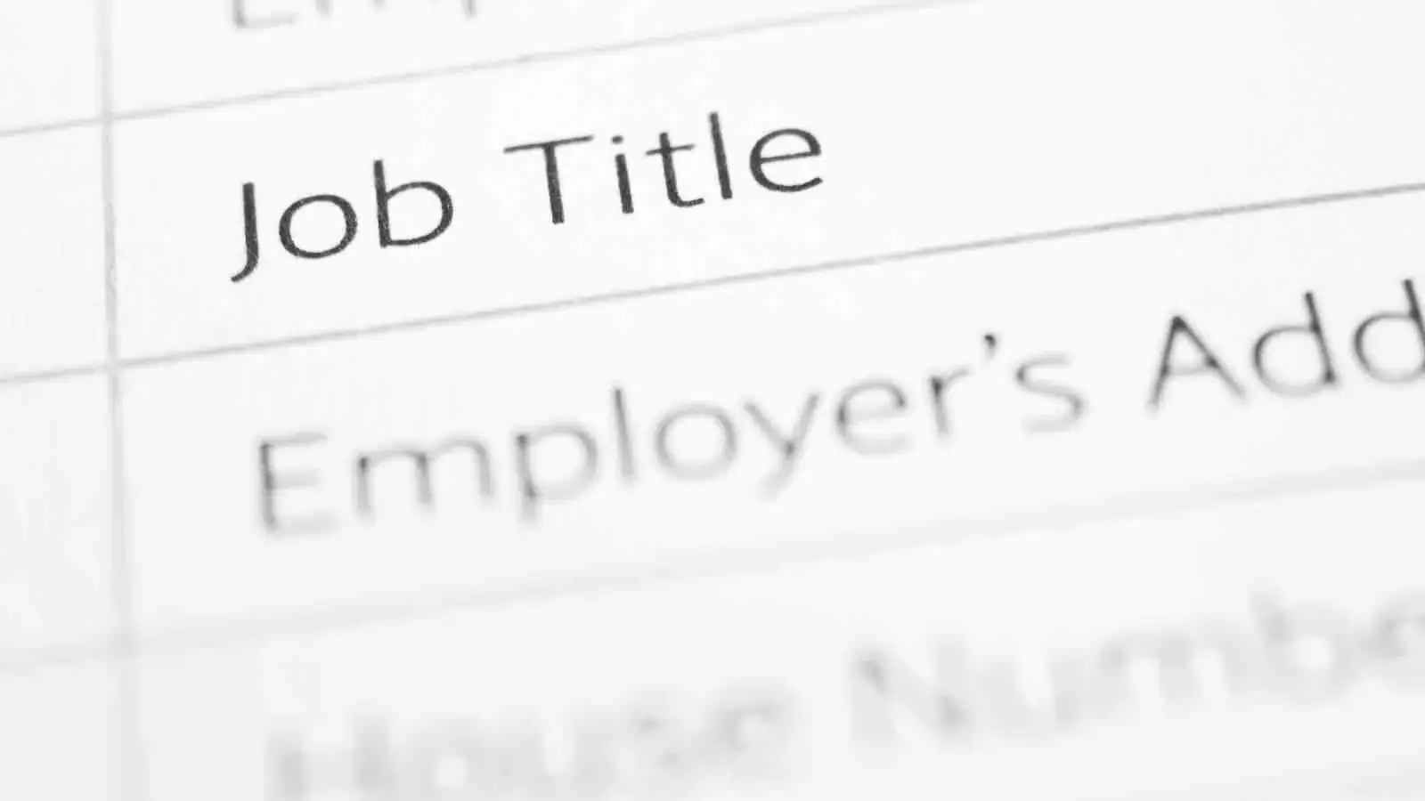 paper with the words ’Job Title’ written on it, symbolizing the contrasting cultural approaches to professional titles between Canada and the United States