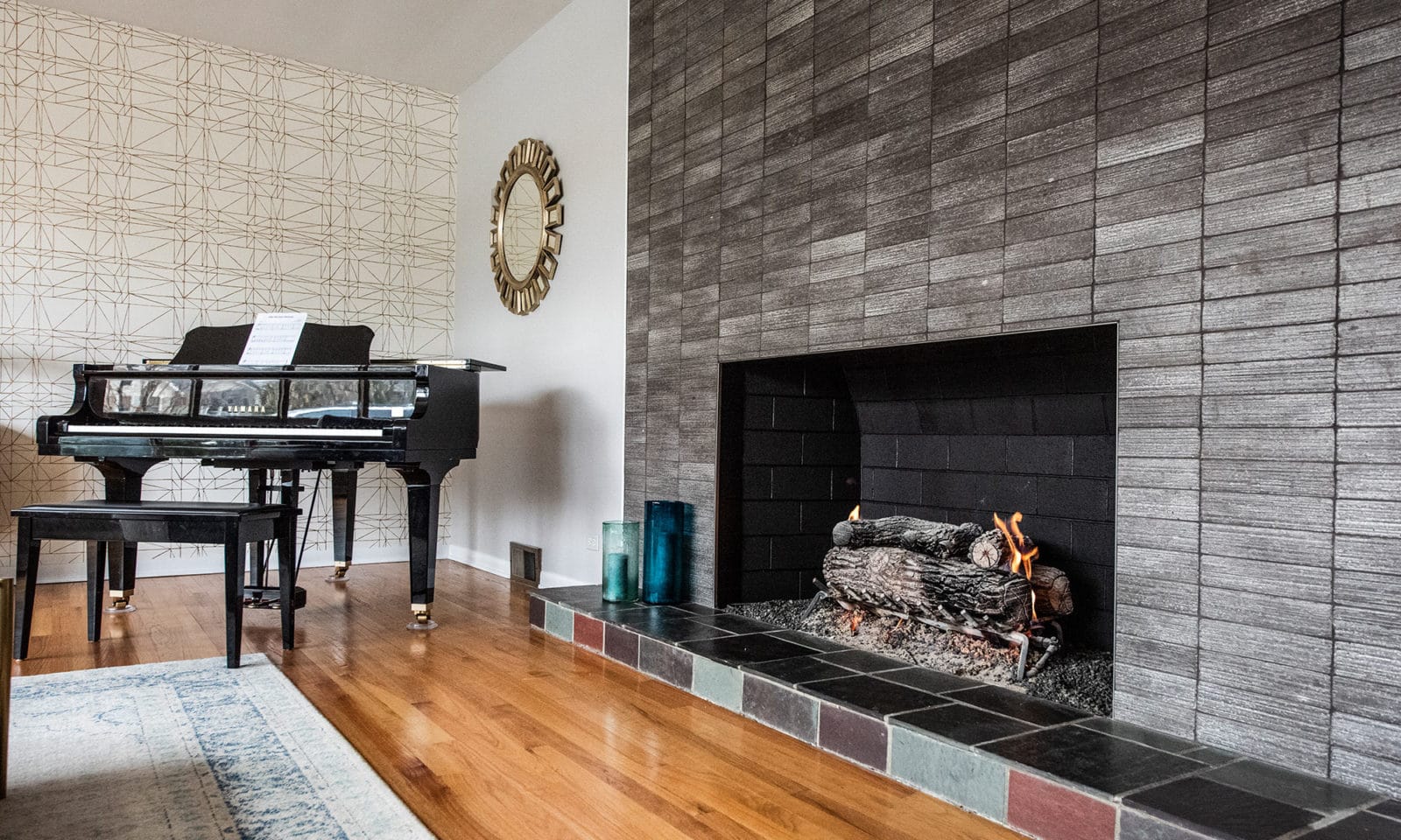 Home remodel with large tiled fire place and piano