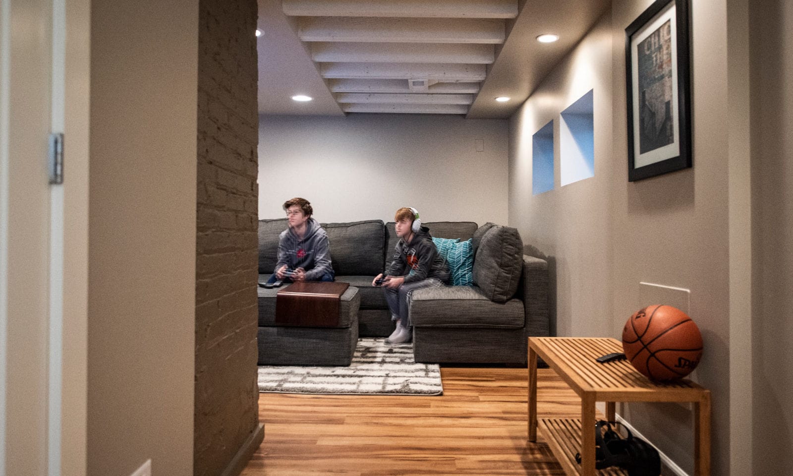 view of basement rec room with kids playing video games
