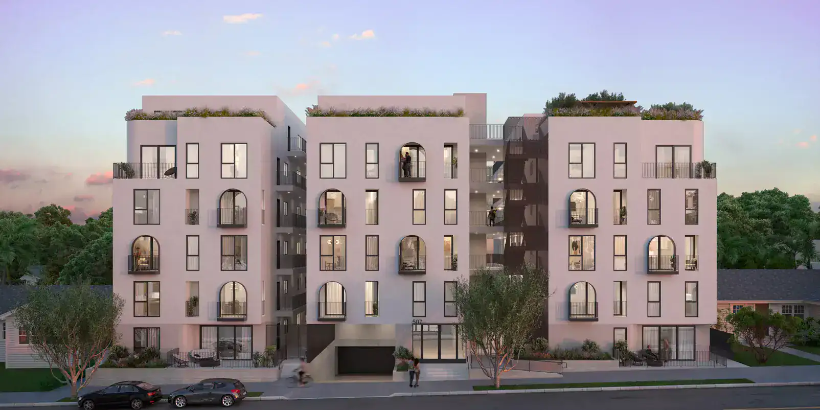 Contemporary residential apartment building with arched windows and rooftop gardens.