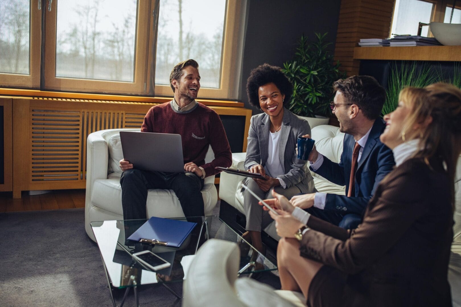 A group of people sitting around each other.