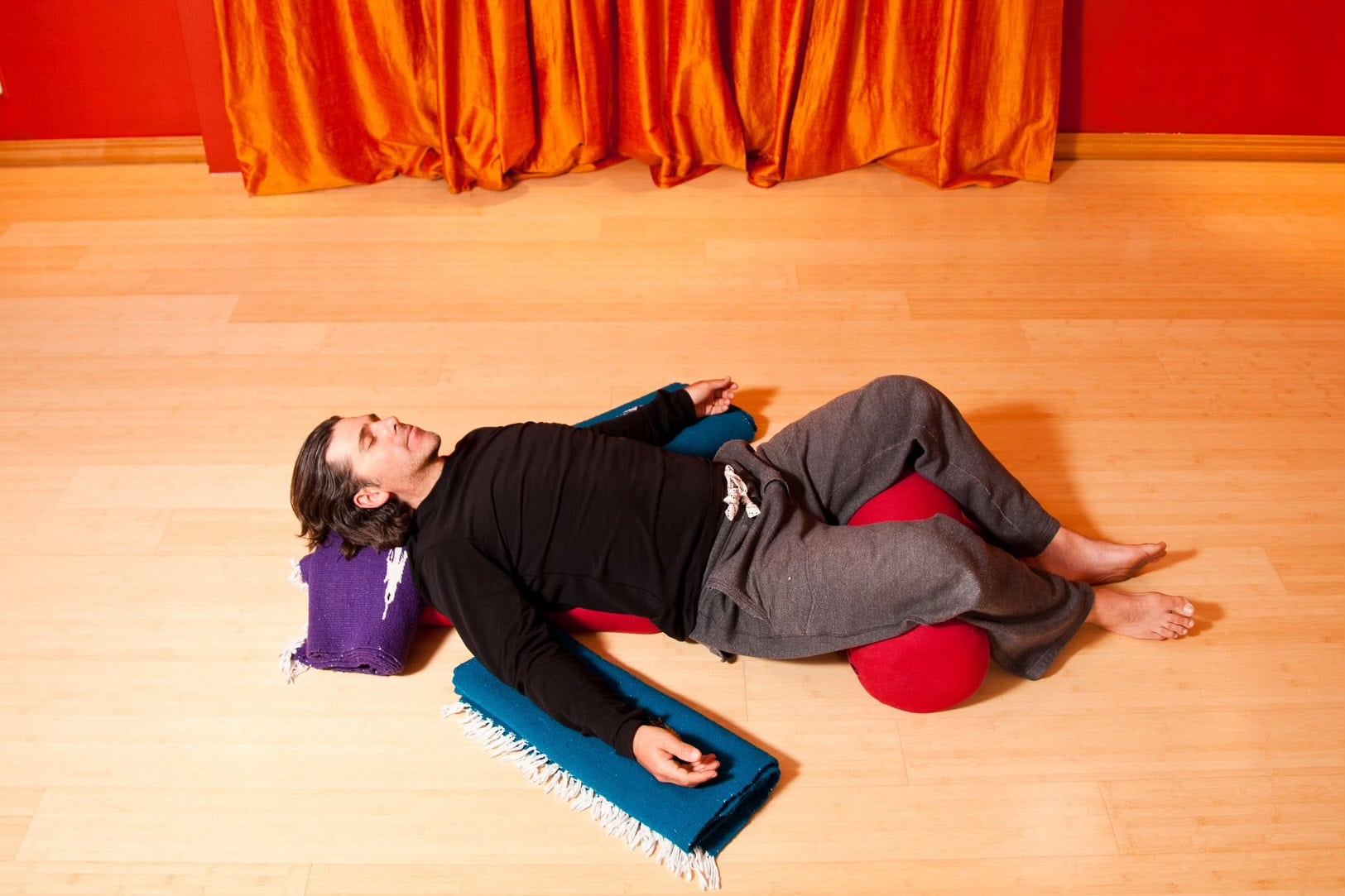 man in restorative yoga class
