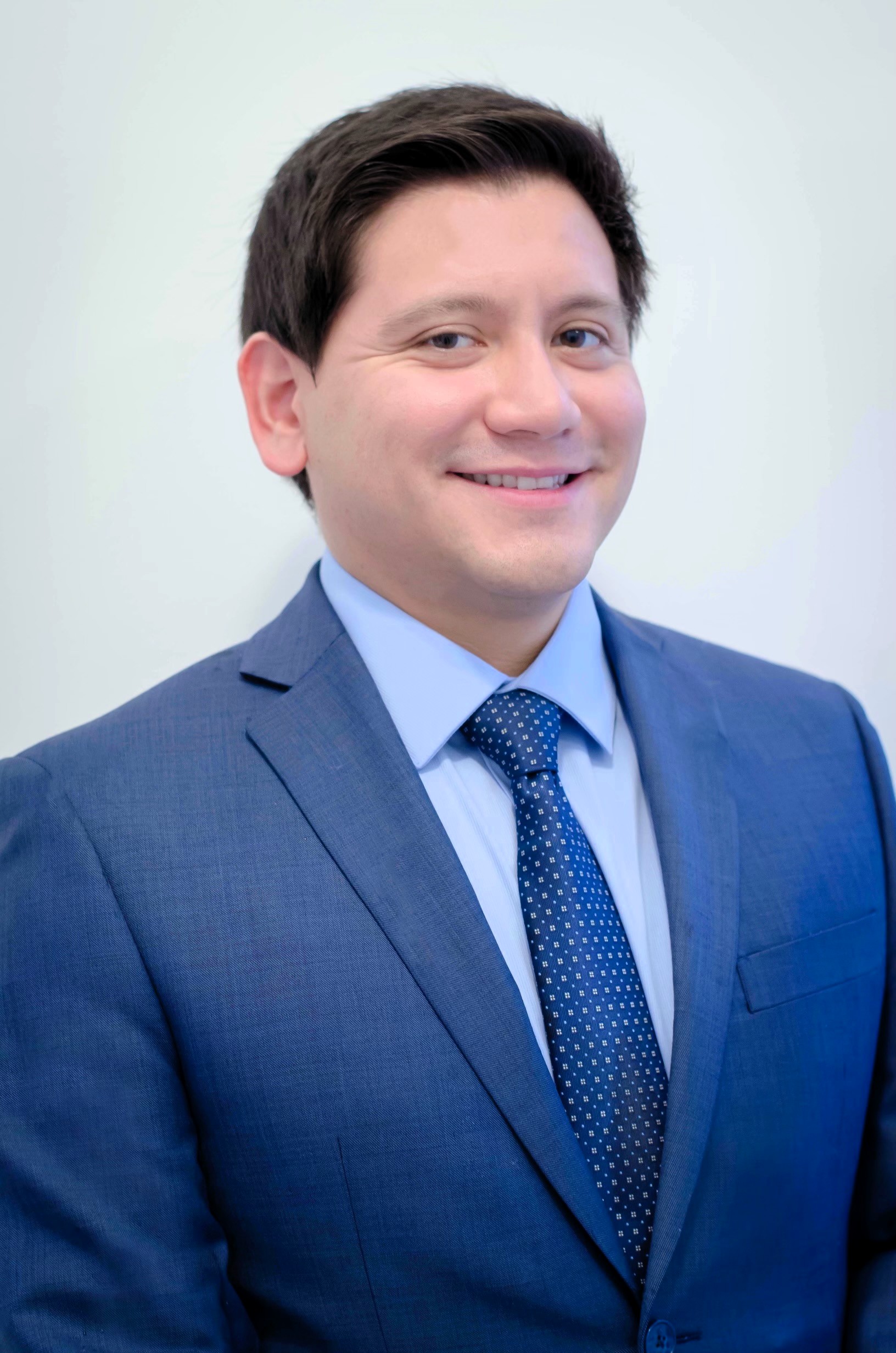 Professional man in blue suit smiling headshot