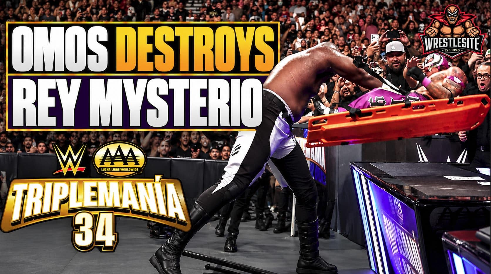 Omos lifts Rey Mysterio while he is strapped to a backboard before slamming him through a table at Triplemanía 34