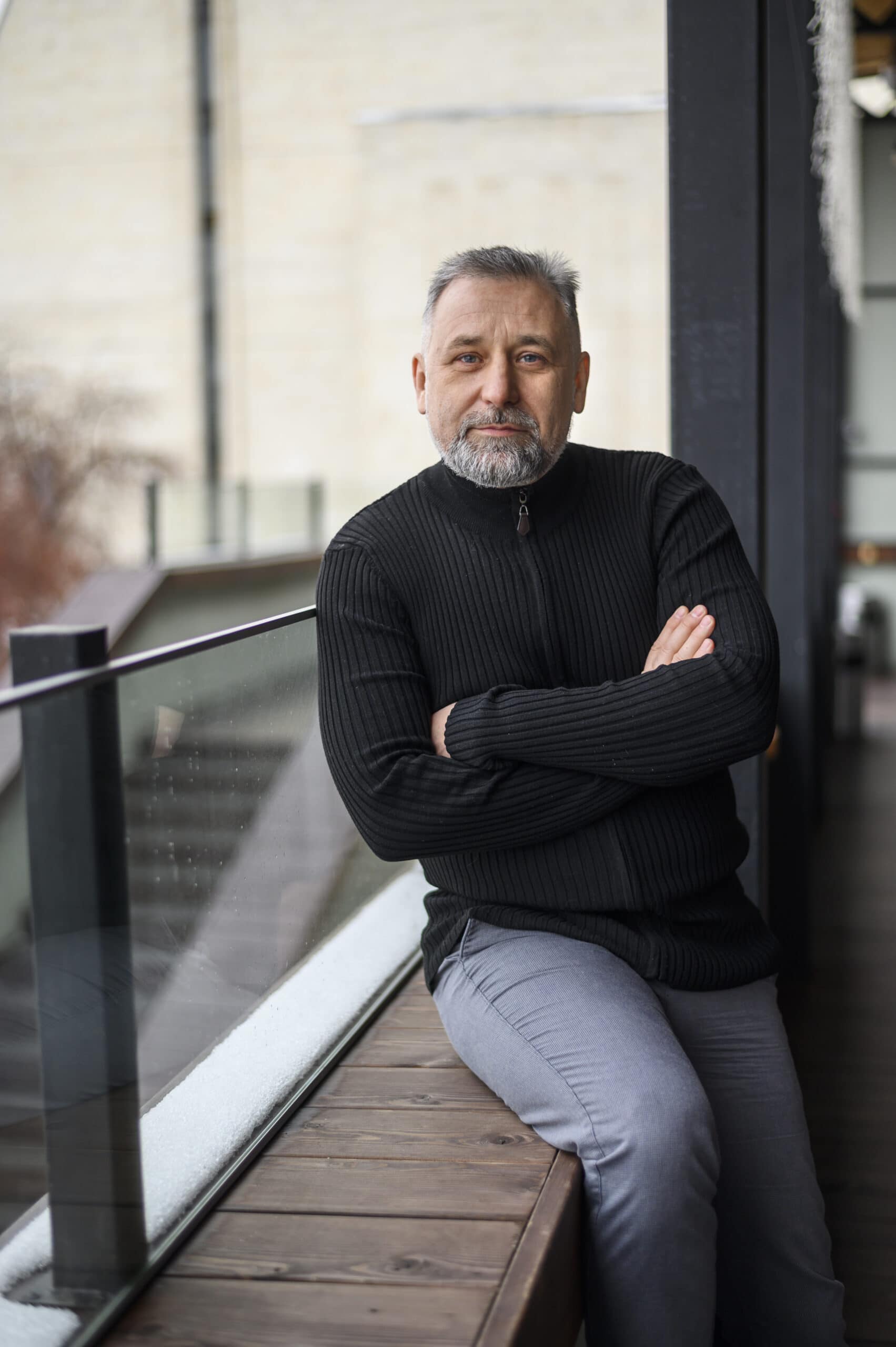 About us 1 mature man sitting sill scaled