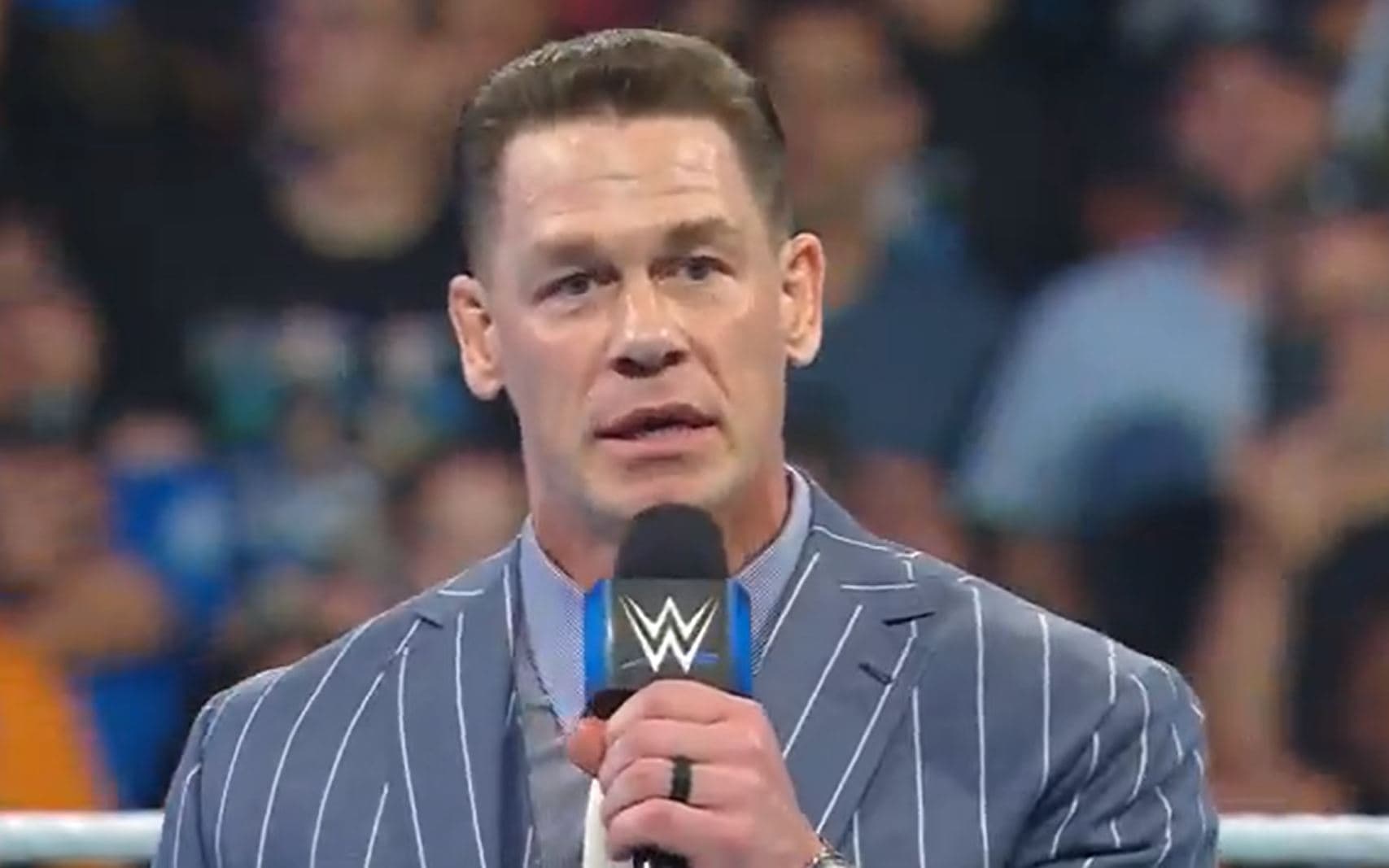 John Cena standing in a WWE ring during the announcement of the John Cena Classic concept