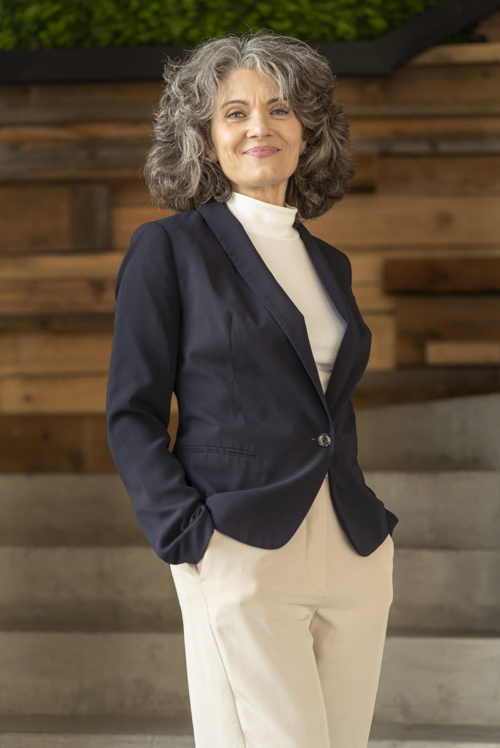 About us 2 portrait business womanwearing suit scaled