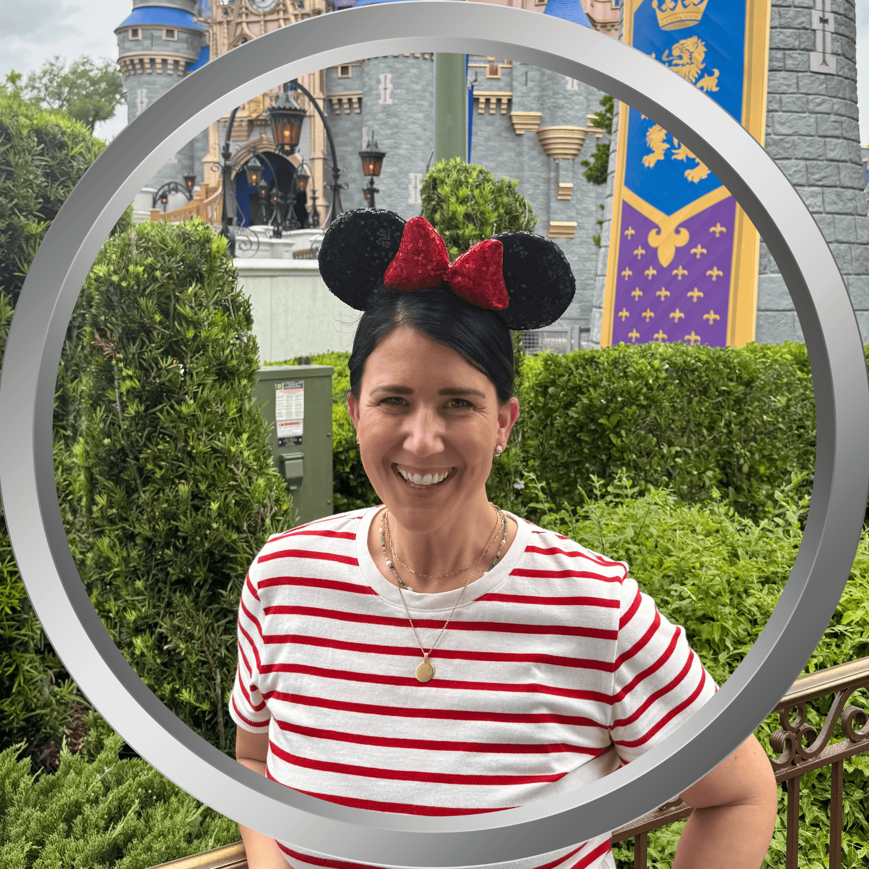 Smiling woman with Minnie Mouse ears at Disney theme park with castle backdrop.