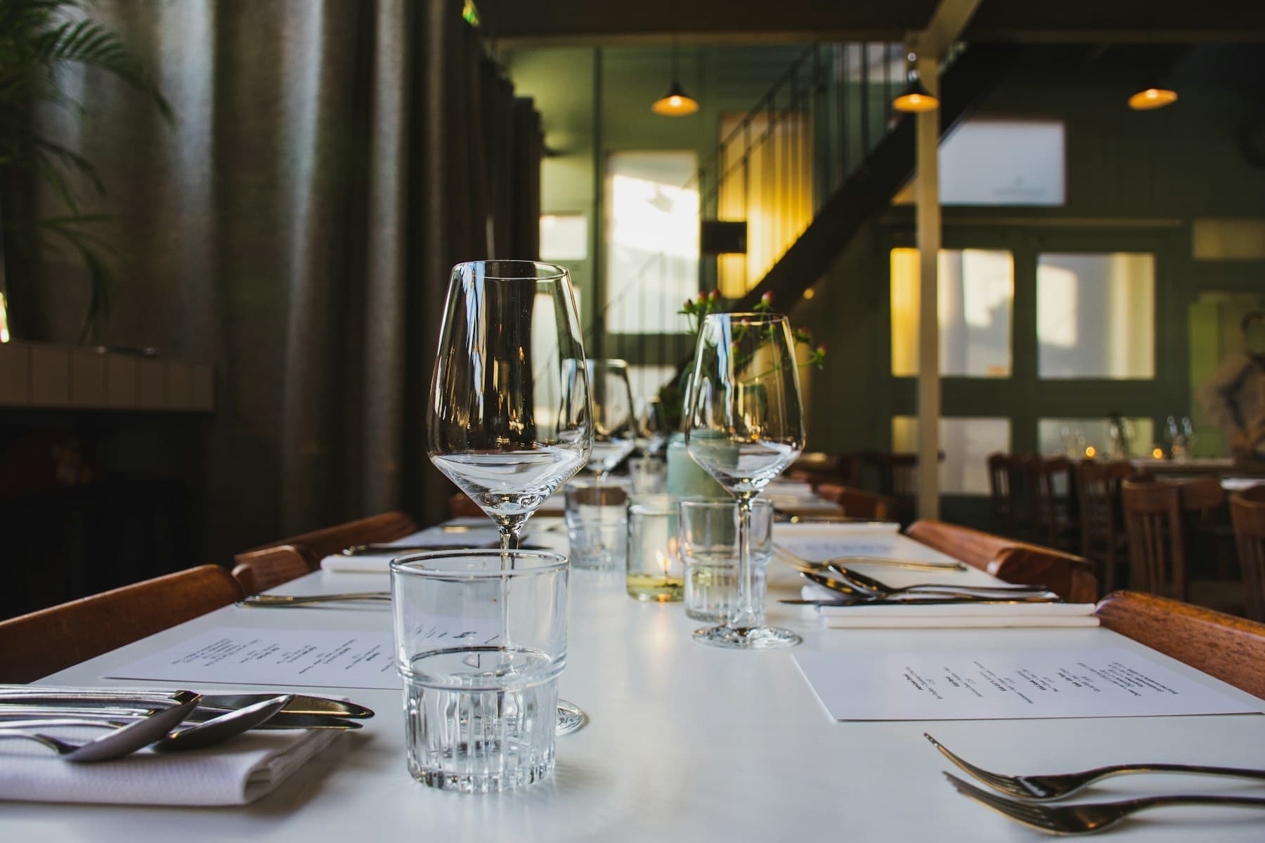 Restaurant dining table set with wine glasses, the setting of a Food & Wine en Español feature