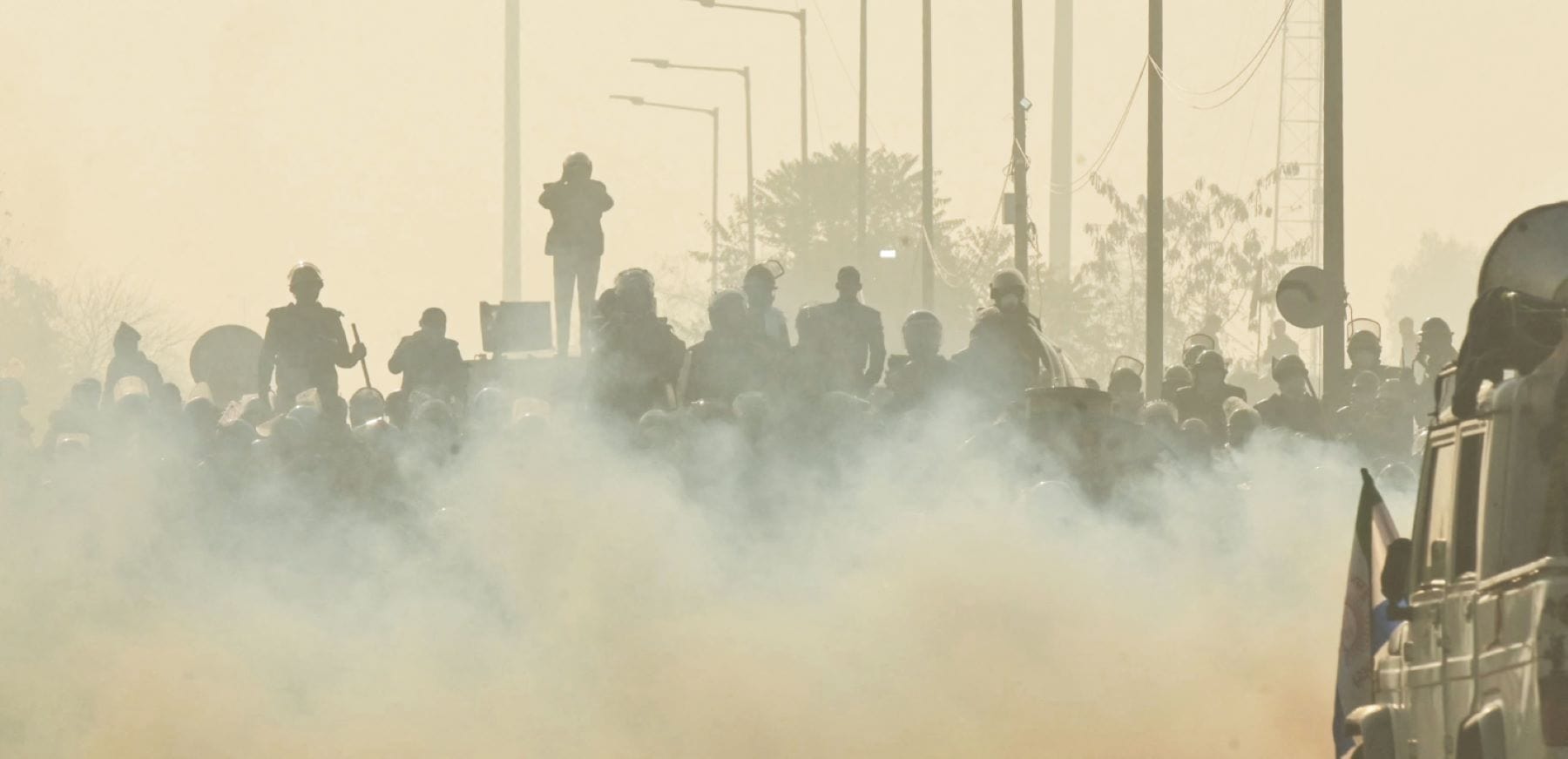 Police and Rapid Action Force (RAF) personnel fire teargas and block a highway to prevent farmers from marching towards New Delhi during a protest demanding minimum crop prices, at the Haryana-Punjab state border in Shambhu near Ambala about 200 kilometres (125 miles) north of the capital on February 14, 2024. Photo by NARINDER NANU/AFP via Getty Images.