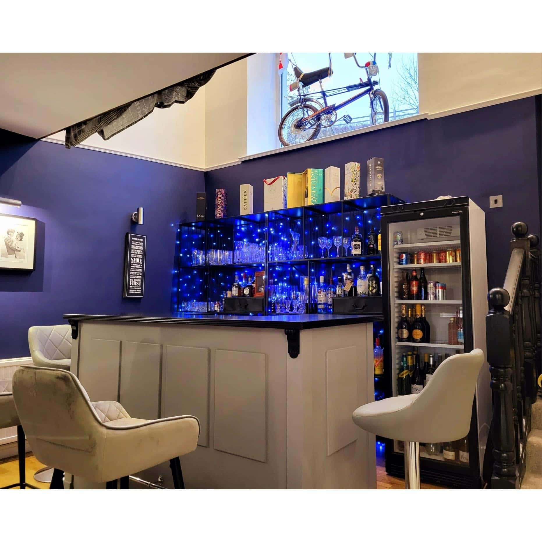 The Abbey bar in a room with blue walls and a vaulted ceiling