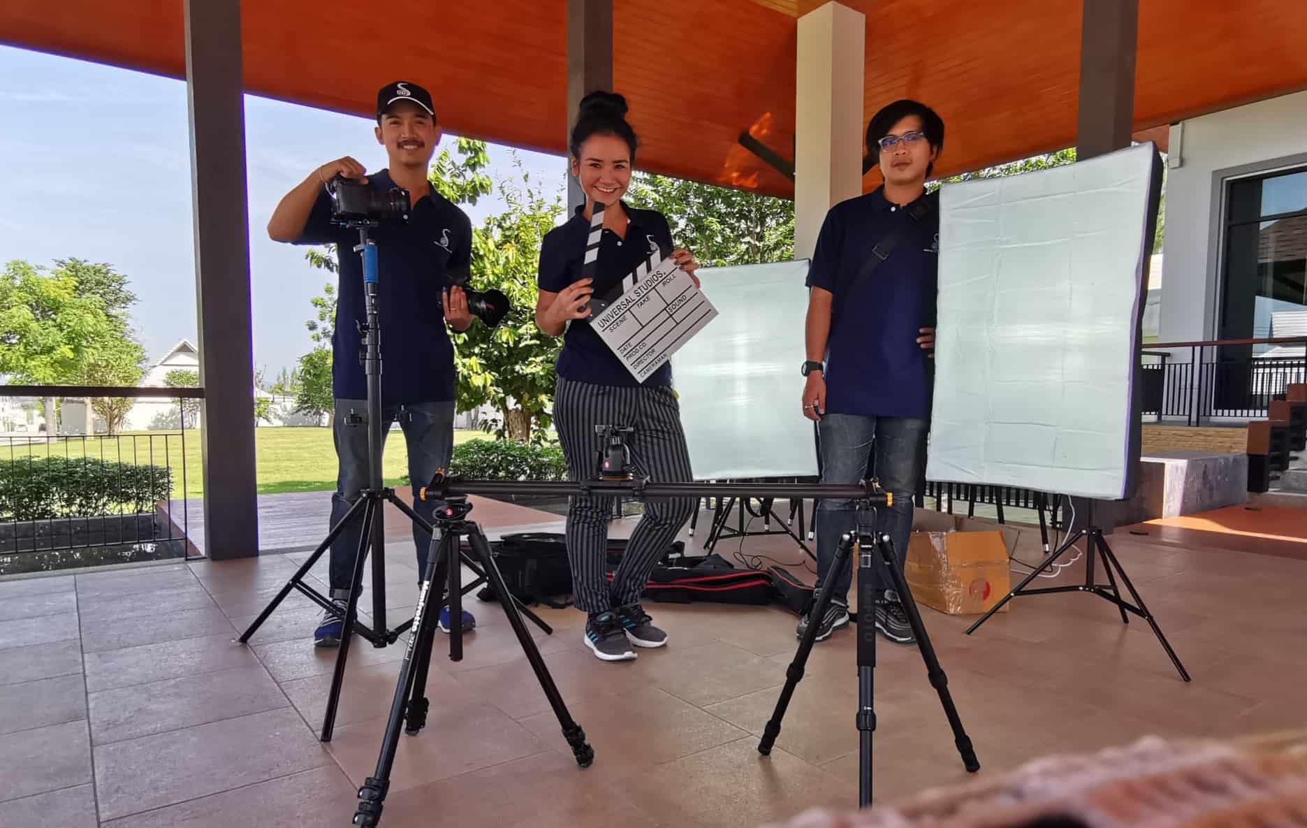 Solasta production team on location with a camera, clapperboard and lighting equipment