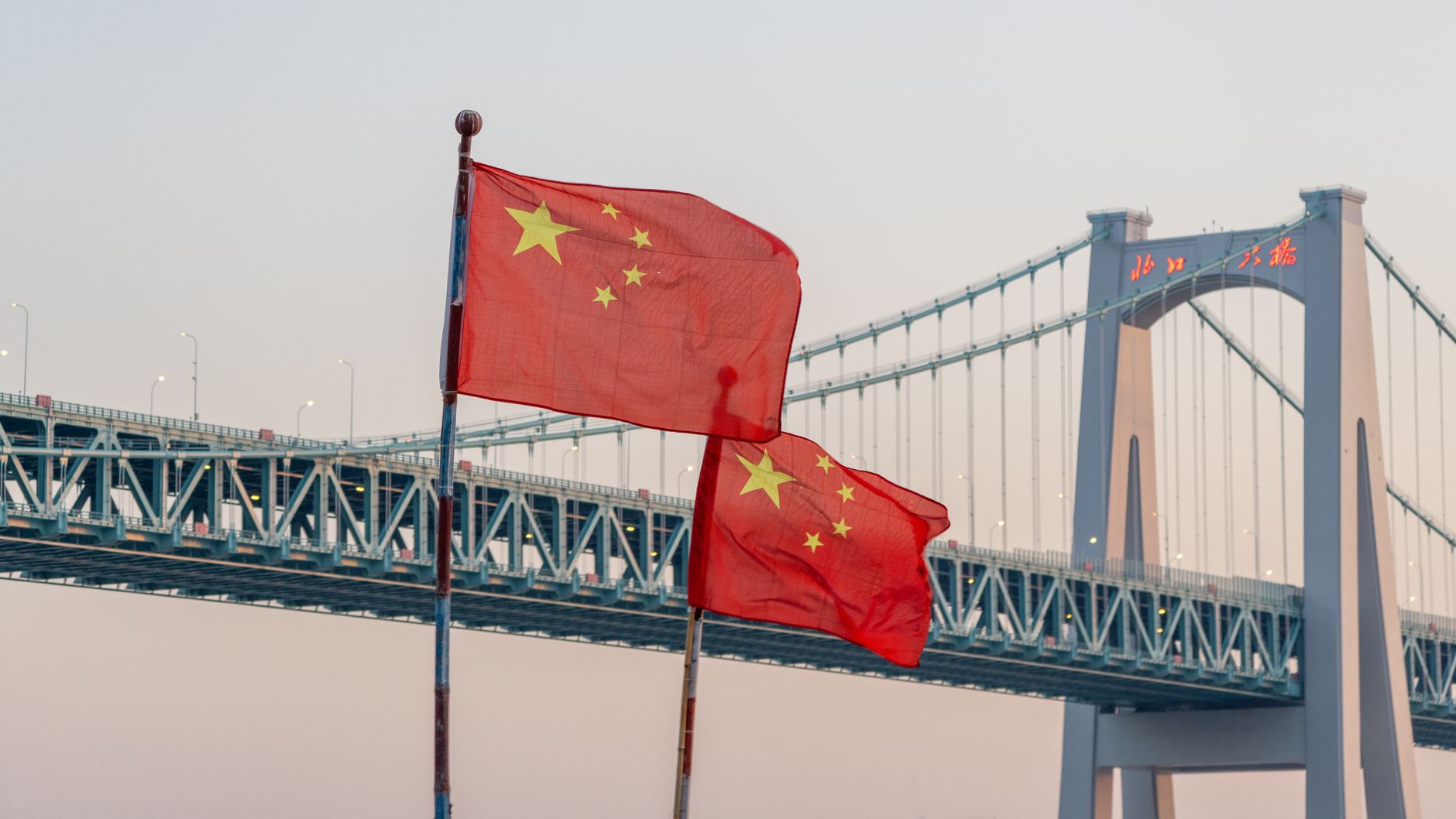 chinese flags and bridge at sunset