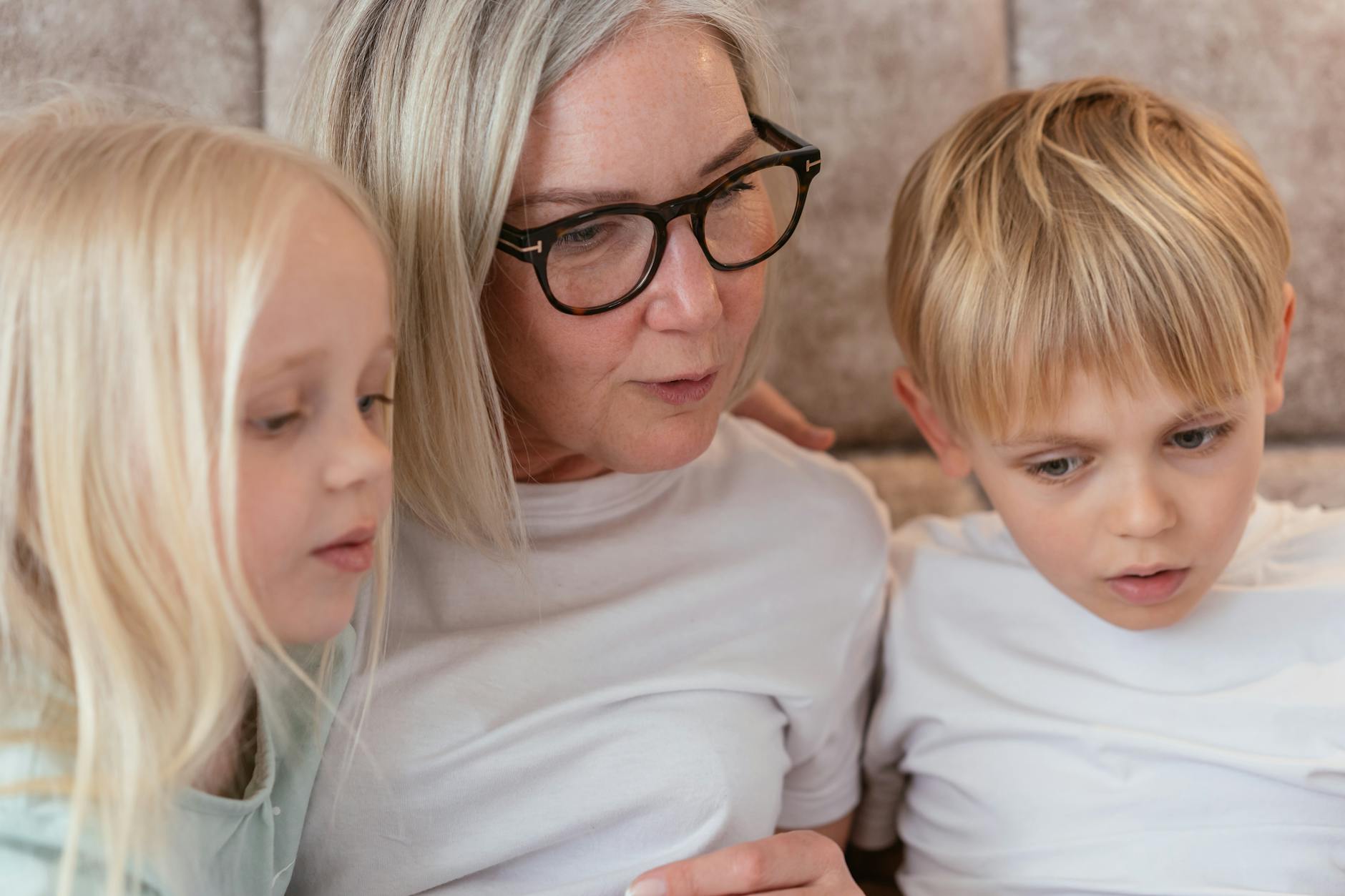an elderly woman having conversation with her grandchildren