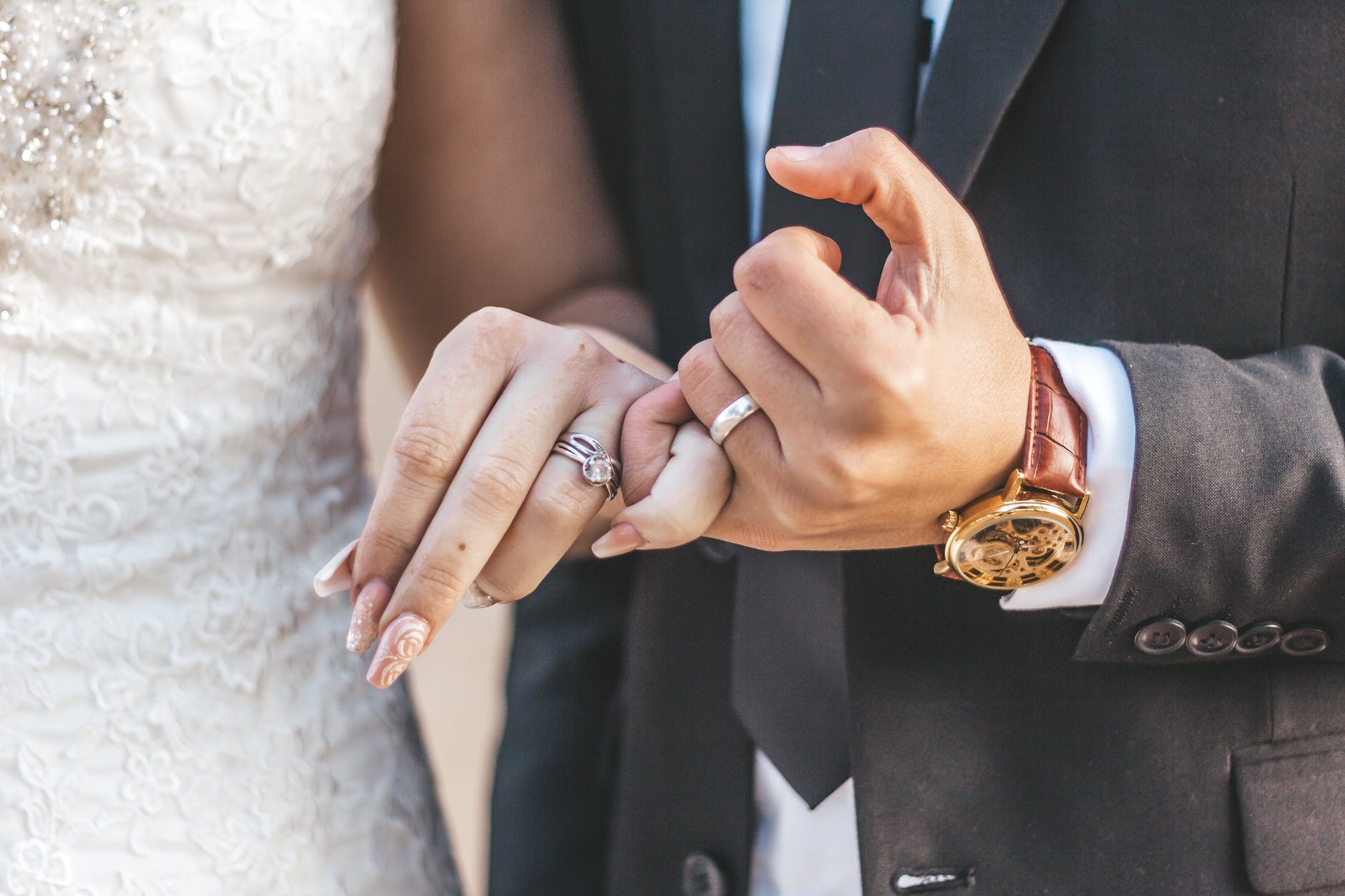 bride and groom doing a pinky swear