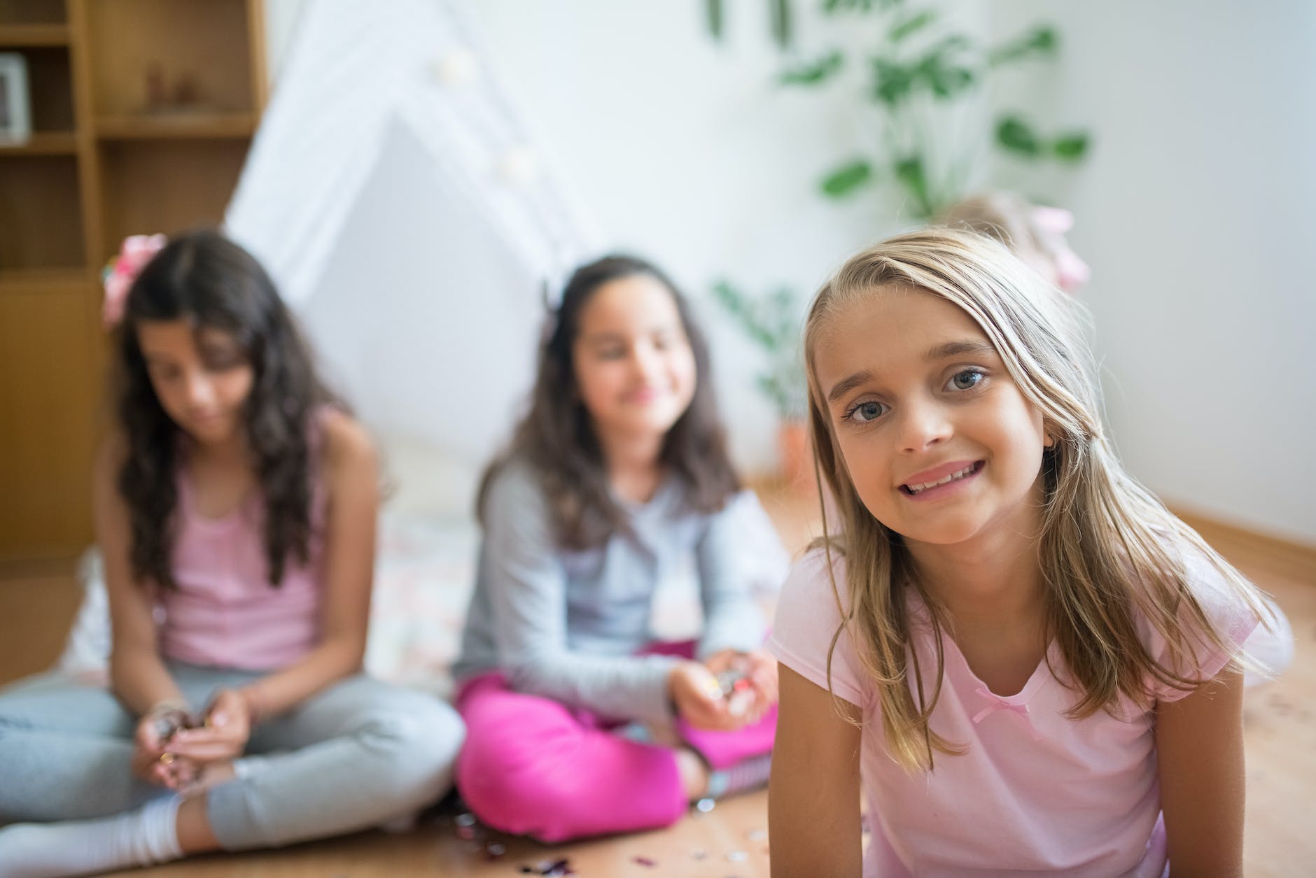 little girls in front of a tent