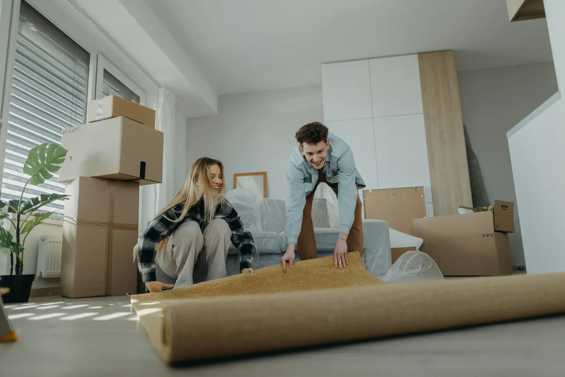A couple following a storage checklist while packing boxes for their move to South Calgary.