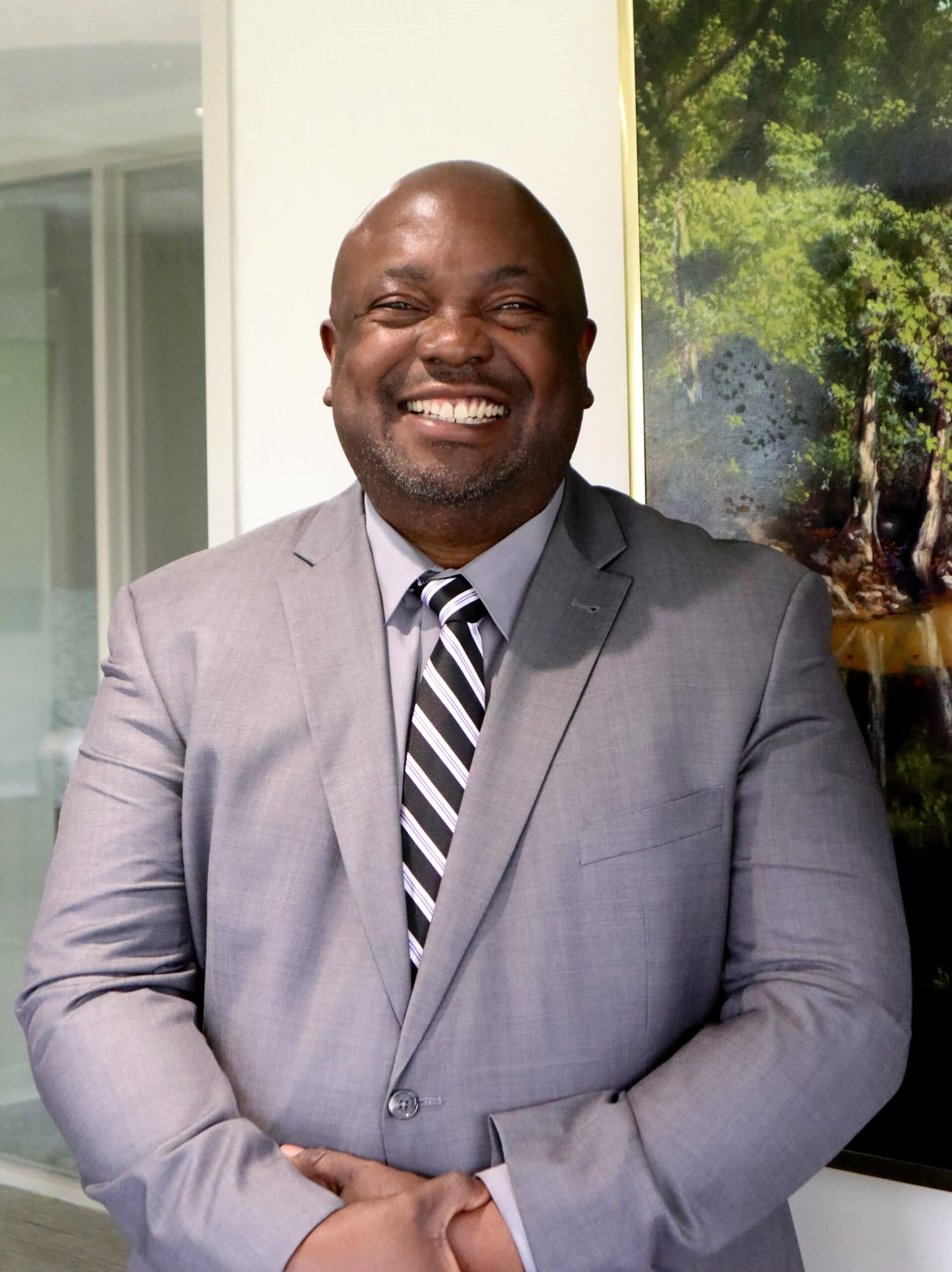 Smiling man in gray suit and striped tie